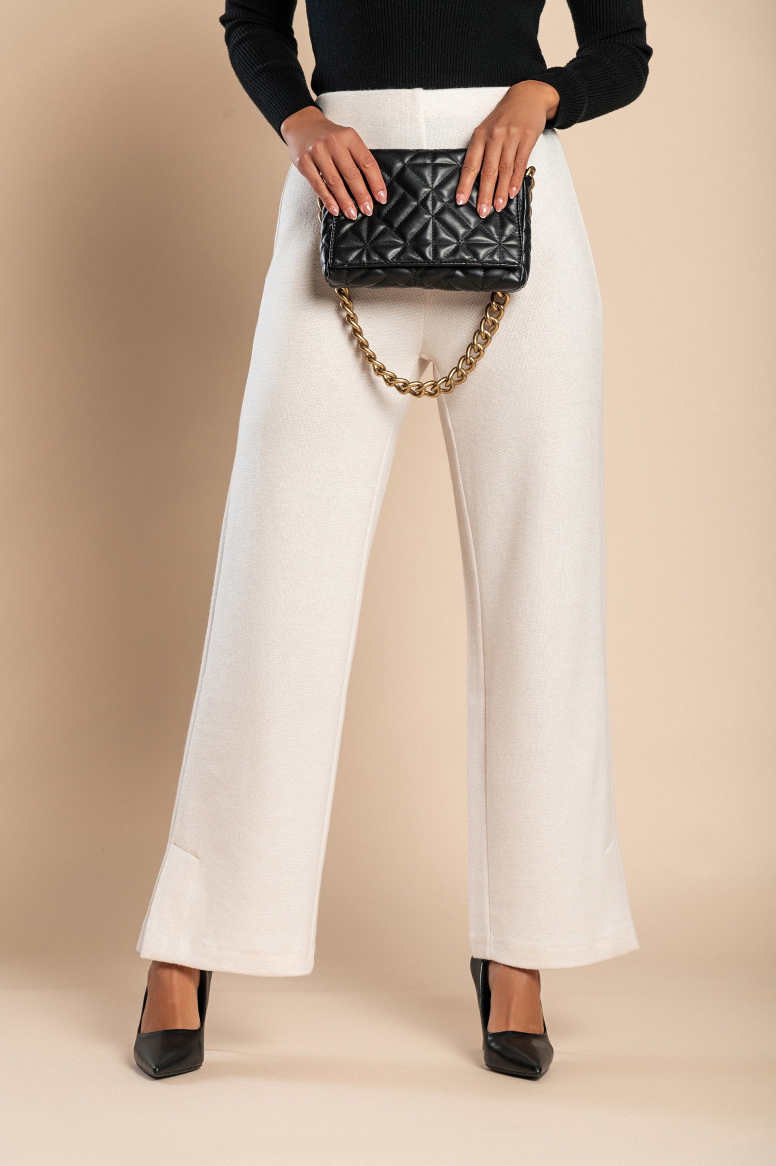 Elegant long white trousers with a straight leg and elasticated waist, made from high-quality fabric, suitable for various occasions.