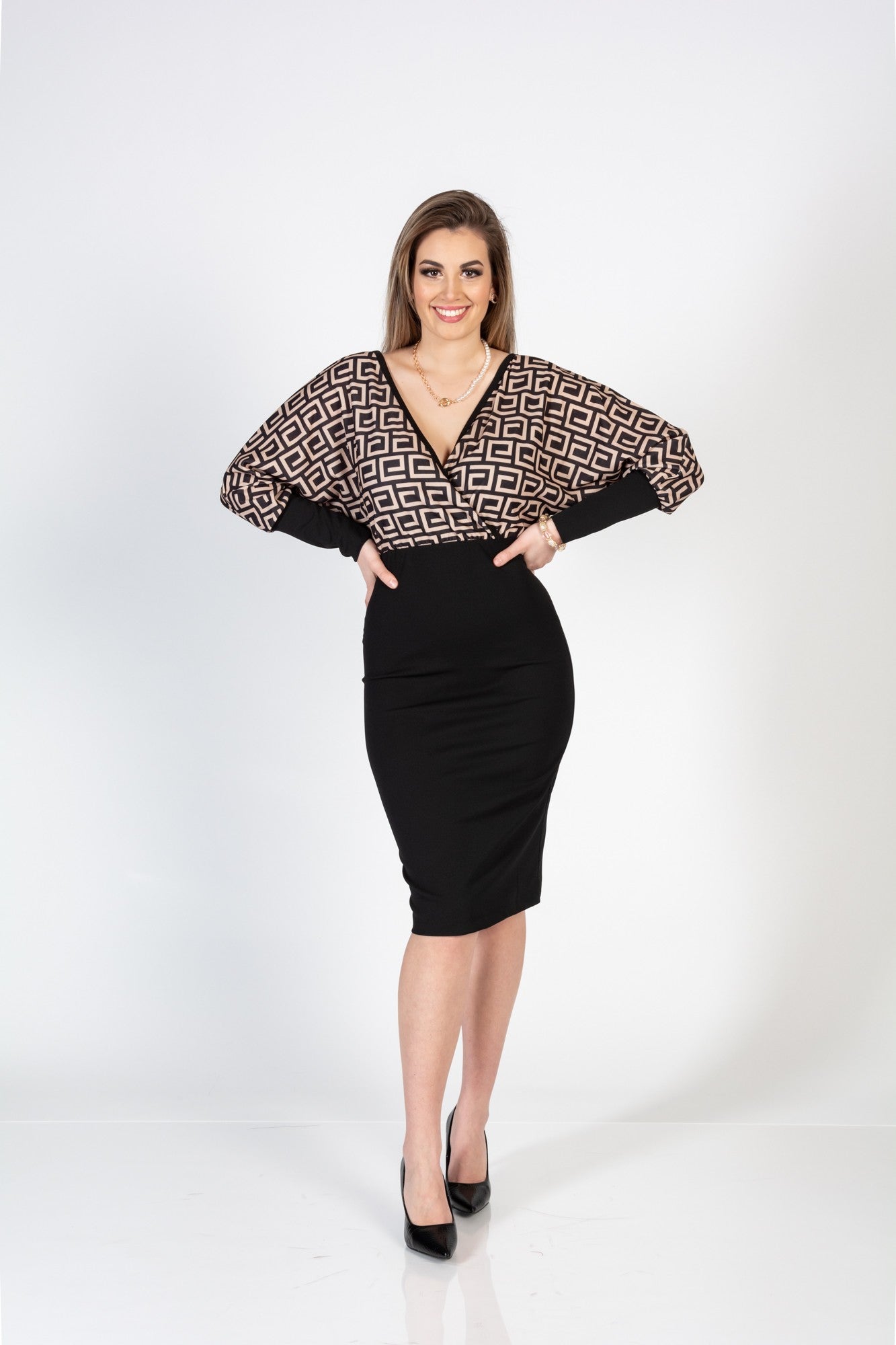 Elegant midi dress featuring a geometric print top, crossover neckline, and fitted solid color skirt, perfect for various occasions.