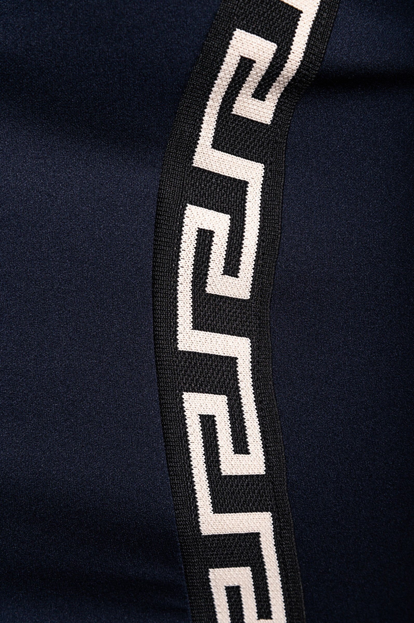 Elegant blue midi dress featuring a geometric print, off-the-shoulder design, and fitted knee-length skirt.