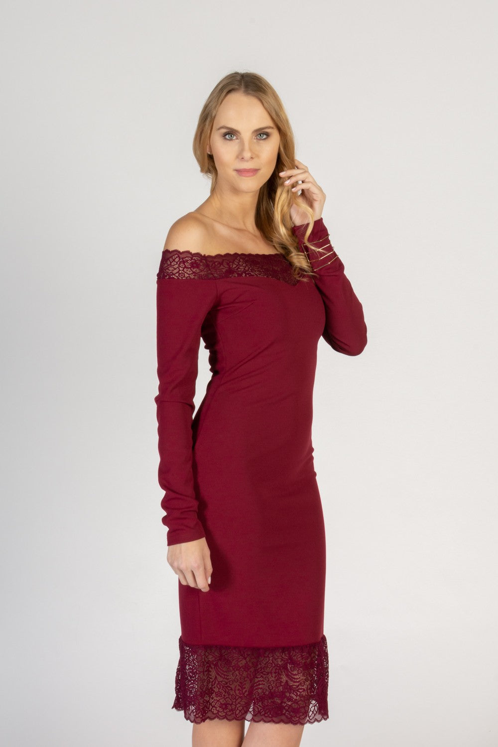 Elegant midi dress featuring long sleeves and translucent lace detail, perfect for formal and casual occasions.