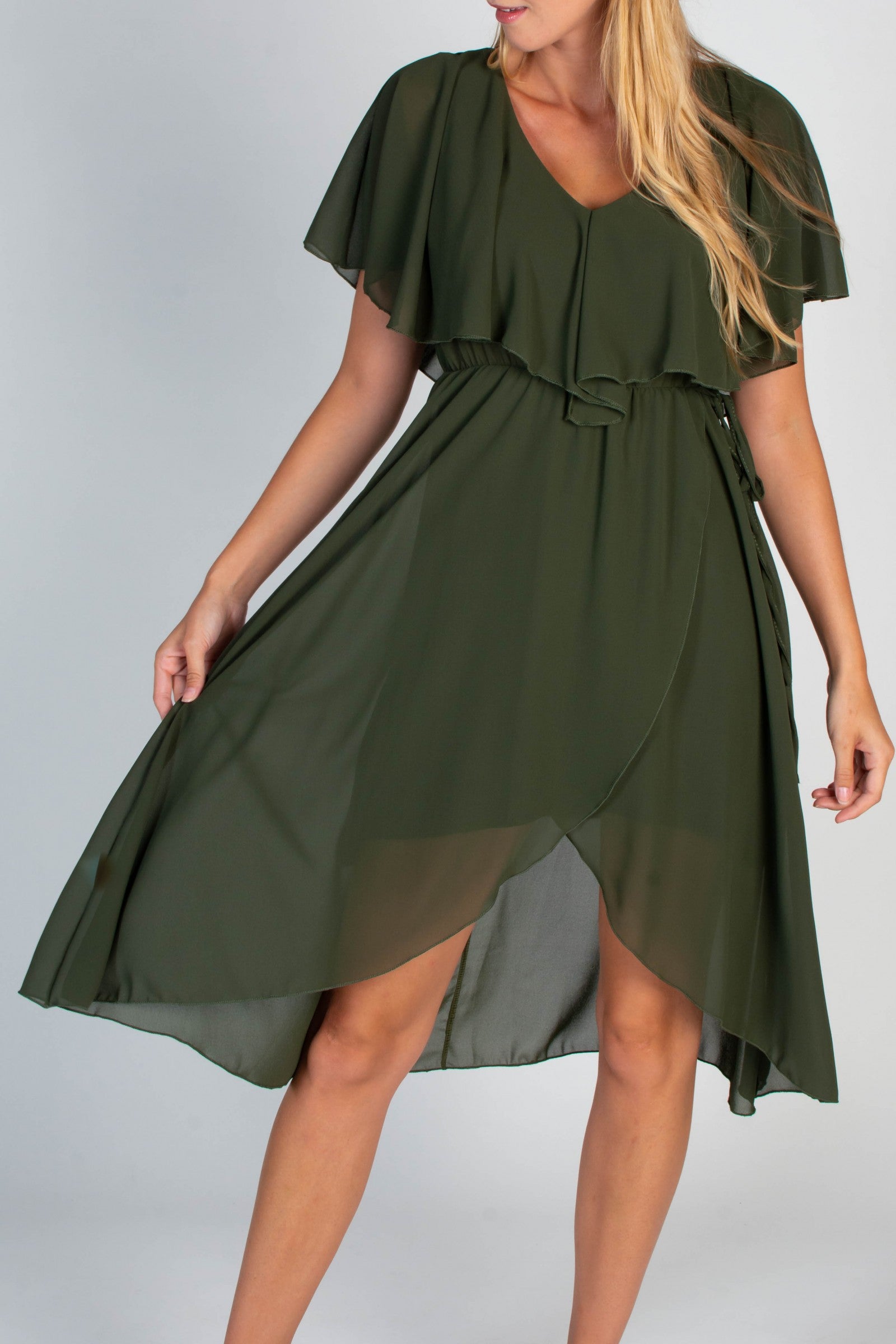Elegant olive midi dress featuring a deep V-neckline, ruffle detail, and an asymmetric wrap skirt, designed for comfort and style.