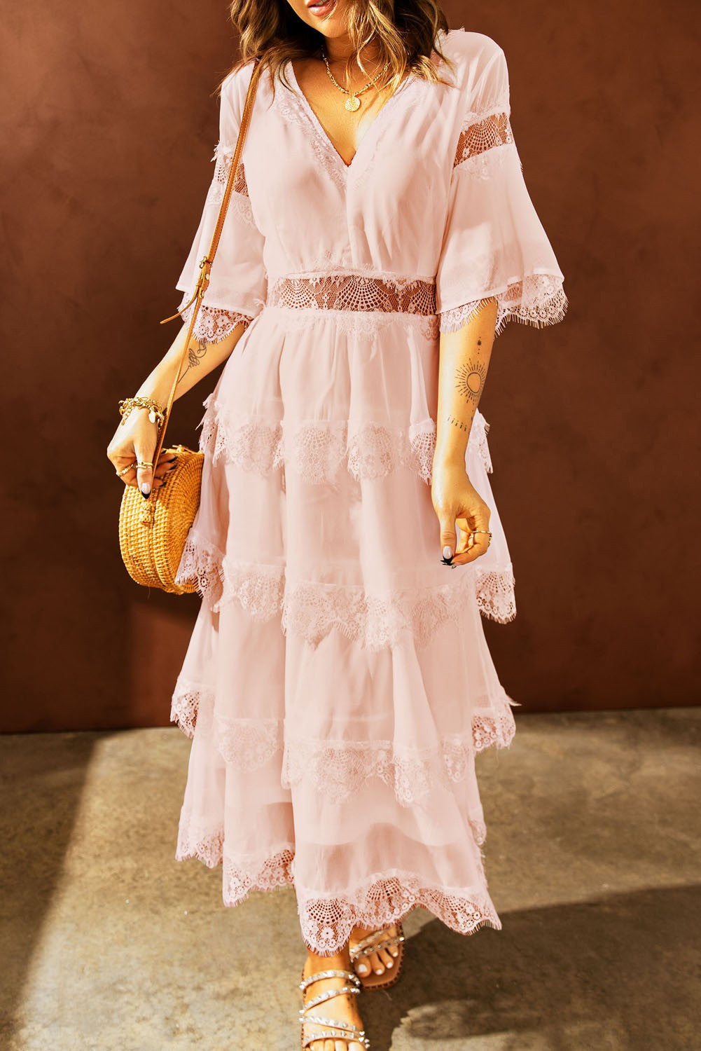 Elegant pink midi dress featuring Tiziana translucent lace inserts, short sleeves, and a deep 'V' neckline.