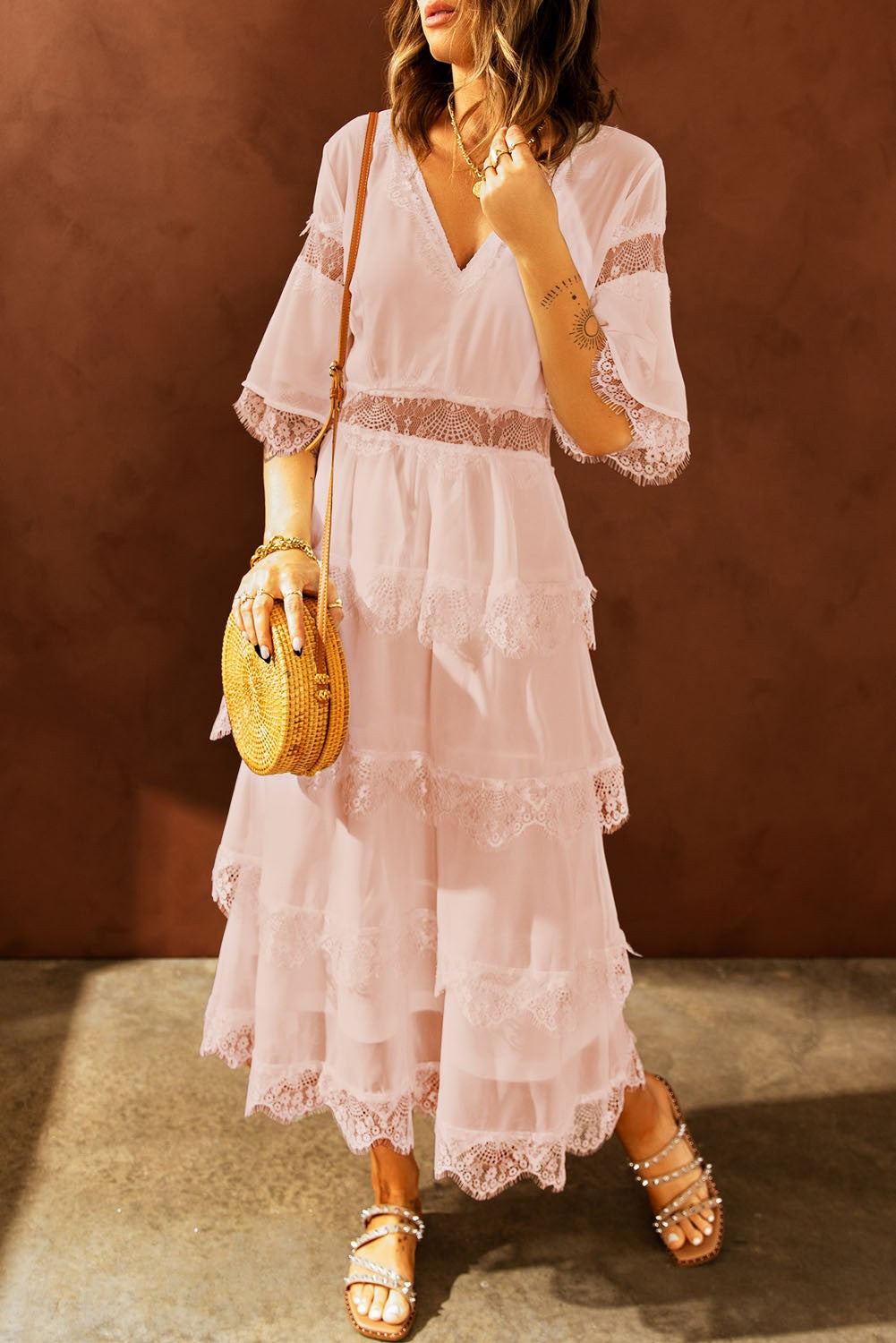 Elegant pink midi dress featuring Tiziana translucent lace inserts, short sleeves, and a deep 'V' neckline.