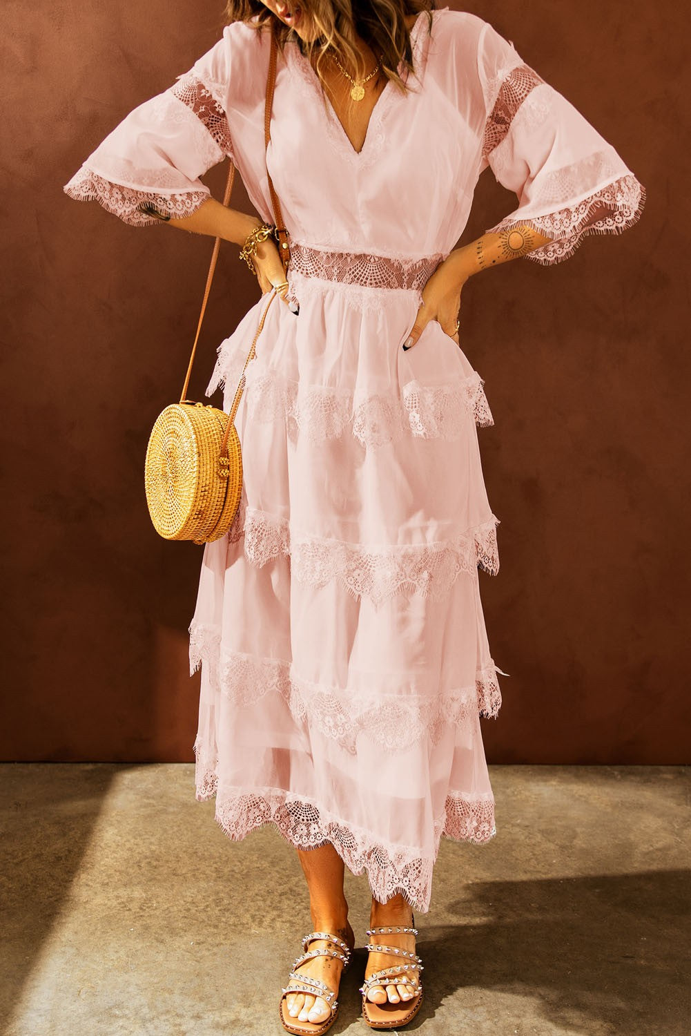 Elegant pink midi dress featuring Tiziana translucent lace inserts, short sleeves, and a deep 'V' neckline.