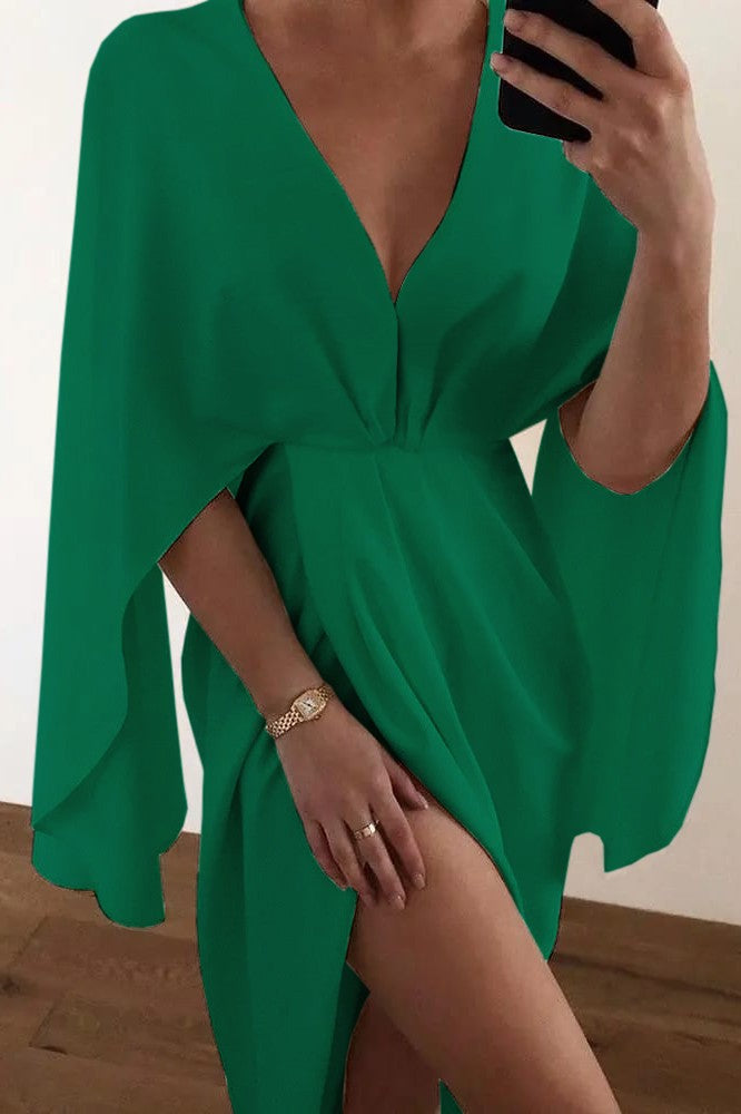 Elegant green mini dress Coccolia with deep neckline and crossed skirt, featuring loose sleeves and mid-thigh length.