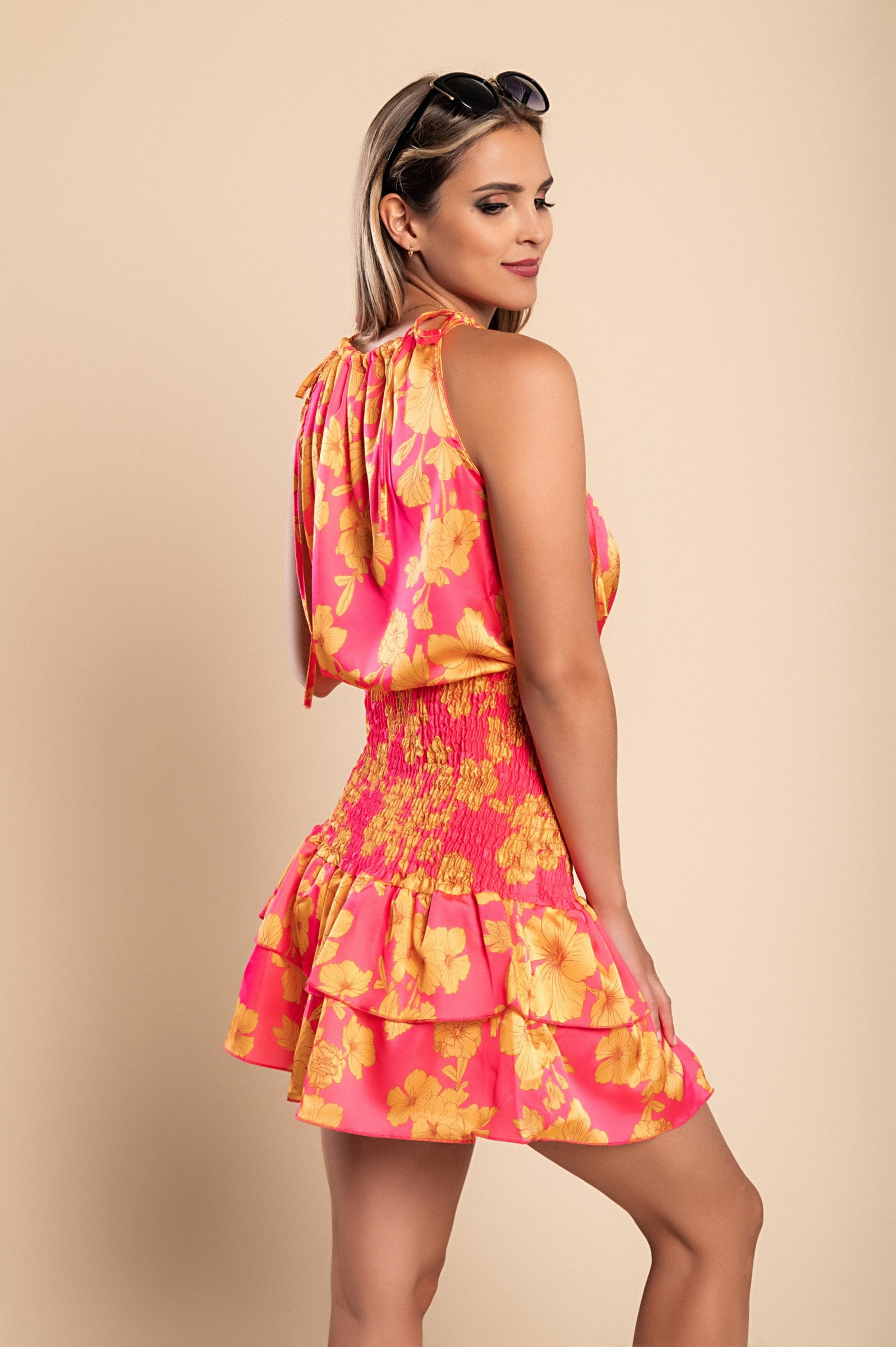 Elegant fuchsia mini dress Torsa with print, featuring a round neckline, thin shoulder straps, and a ruffled mid-thigh skirt.