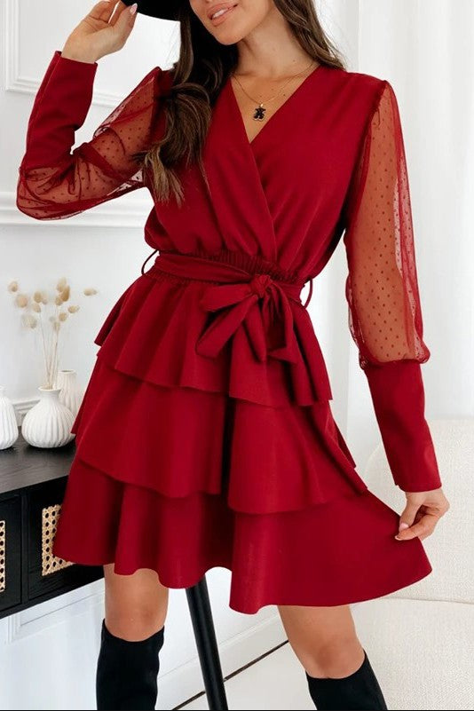 Elegant burgundy mini dress with ruffles, featuring a plunging neckline and sheer tulle long sleeves.