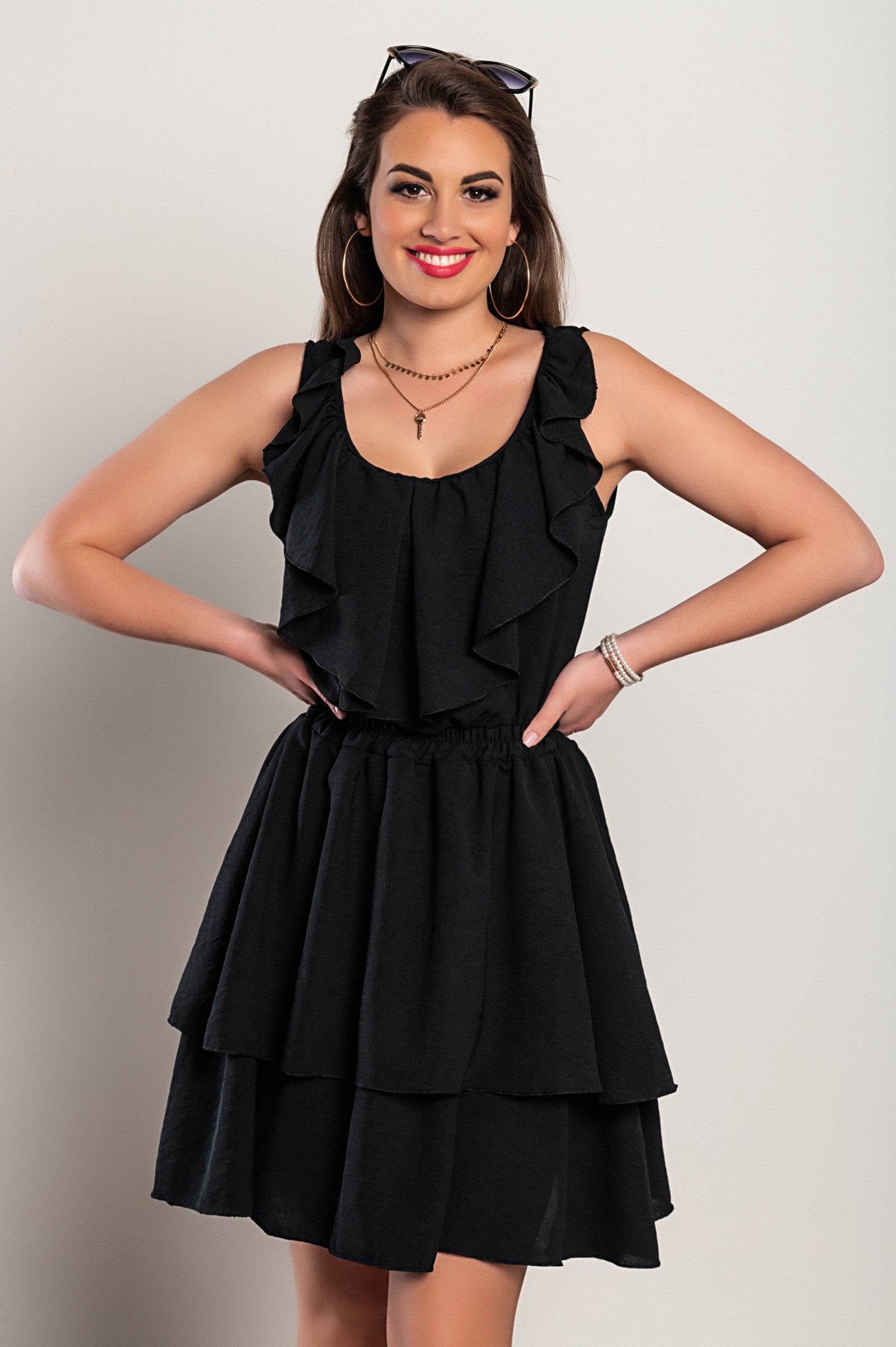 Elegant black mini dress with ruffles, plunging neckline, and wide straps, showcasing a stylish design suitable for various occasions.