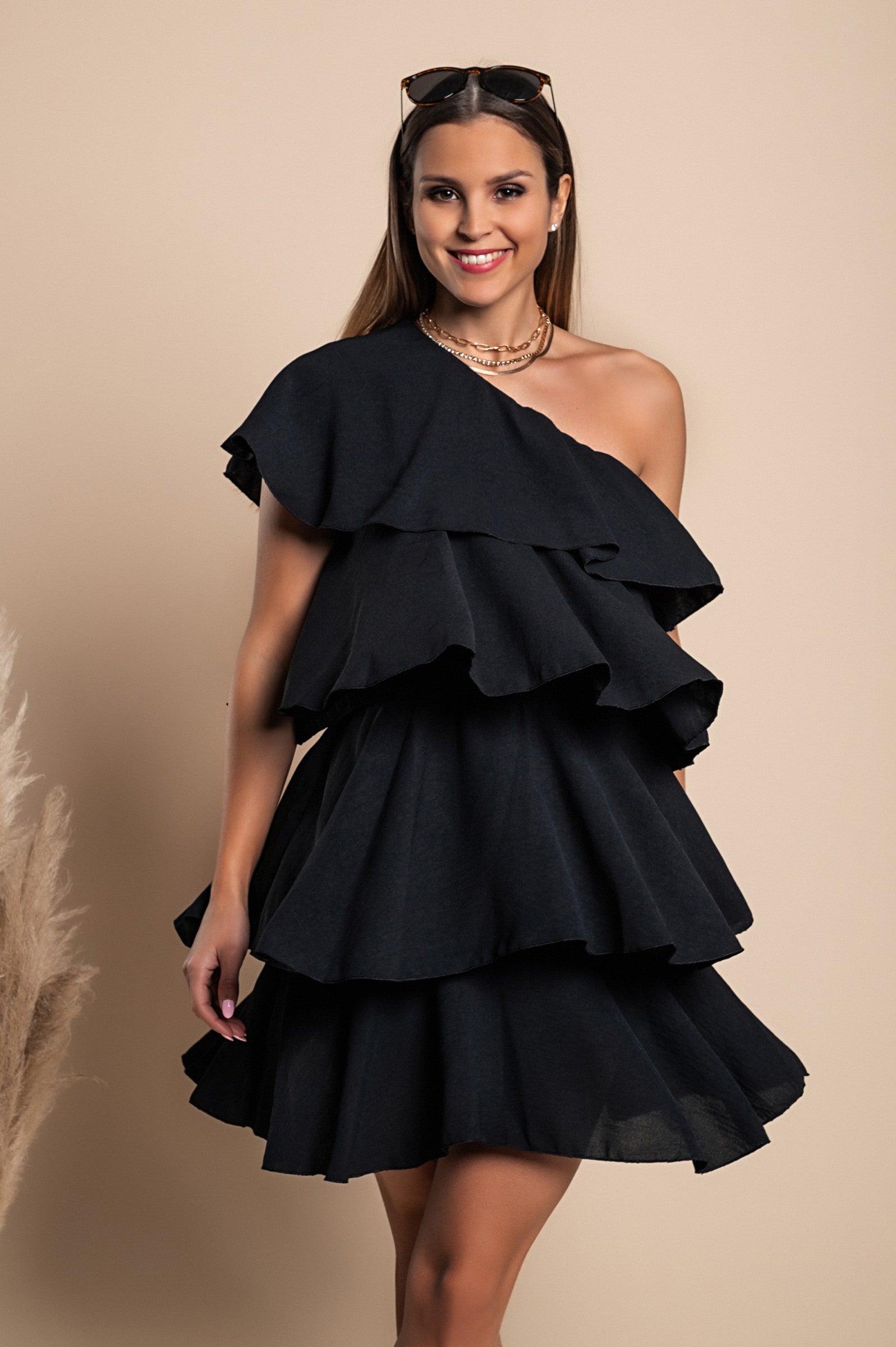 Elegant black mini dress with ruffles, featuring an asymmetrical neckline and one strap, designed for comfort and style.