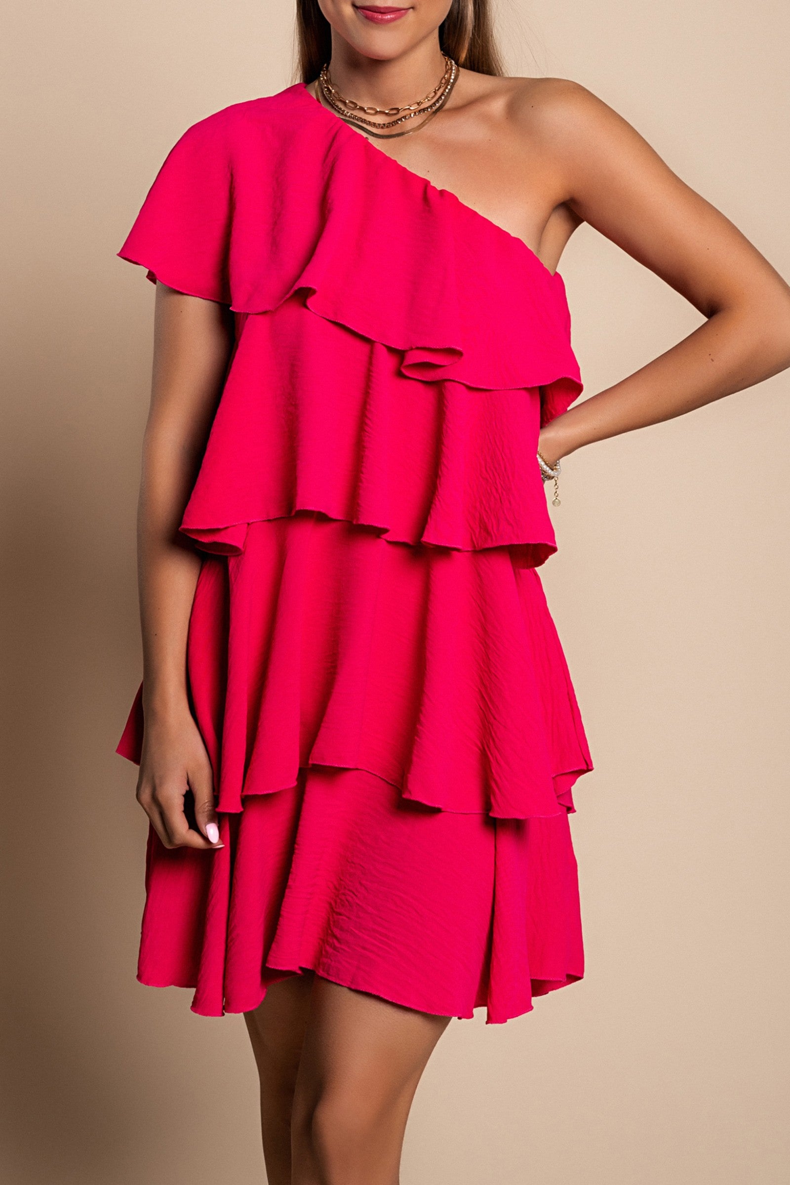 Elegant pink mini dress with ruffles, featuring an asymmetrical neckline and one strap, made from soft polyester fabric.