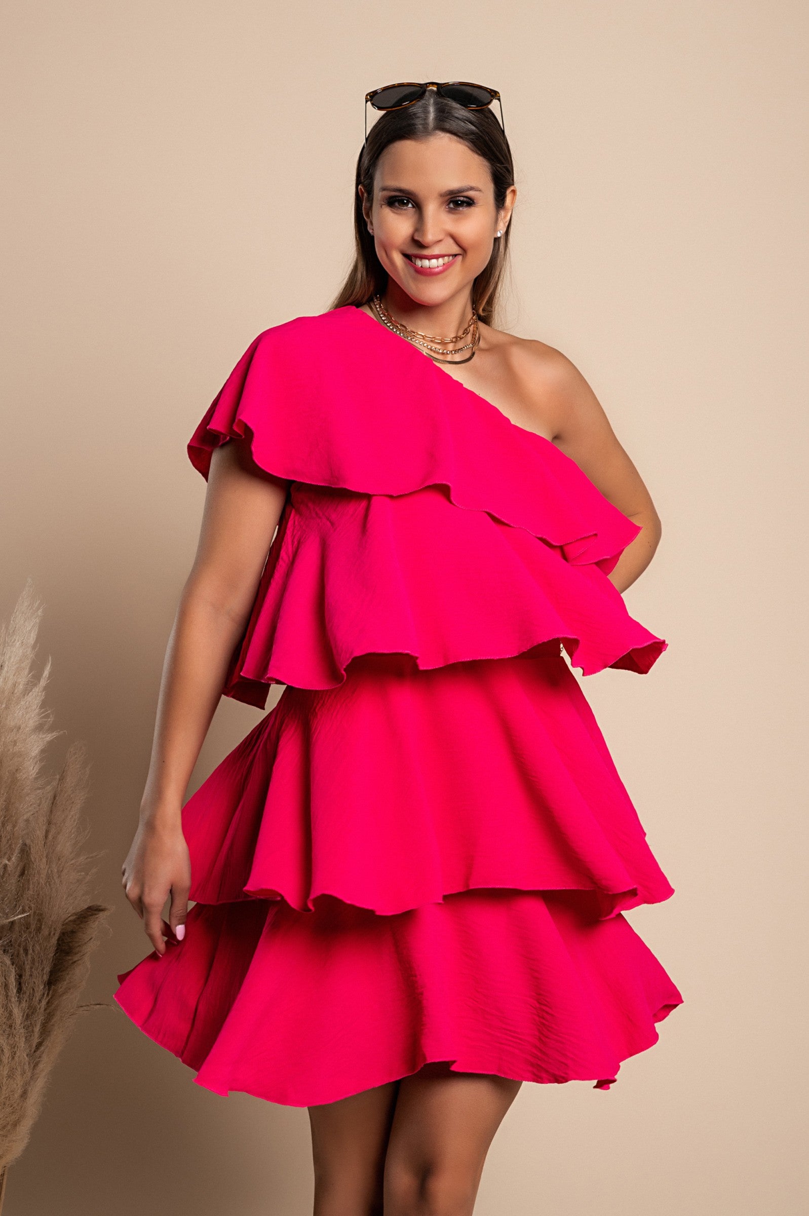 Elegant pink mini dress with ruffles, featuring an asymmetrical neckline and one strap, made from soft polyester fabric.