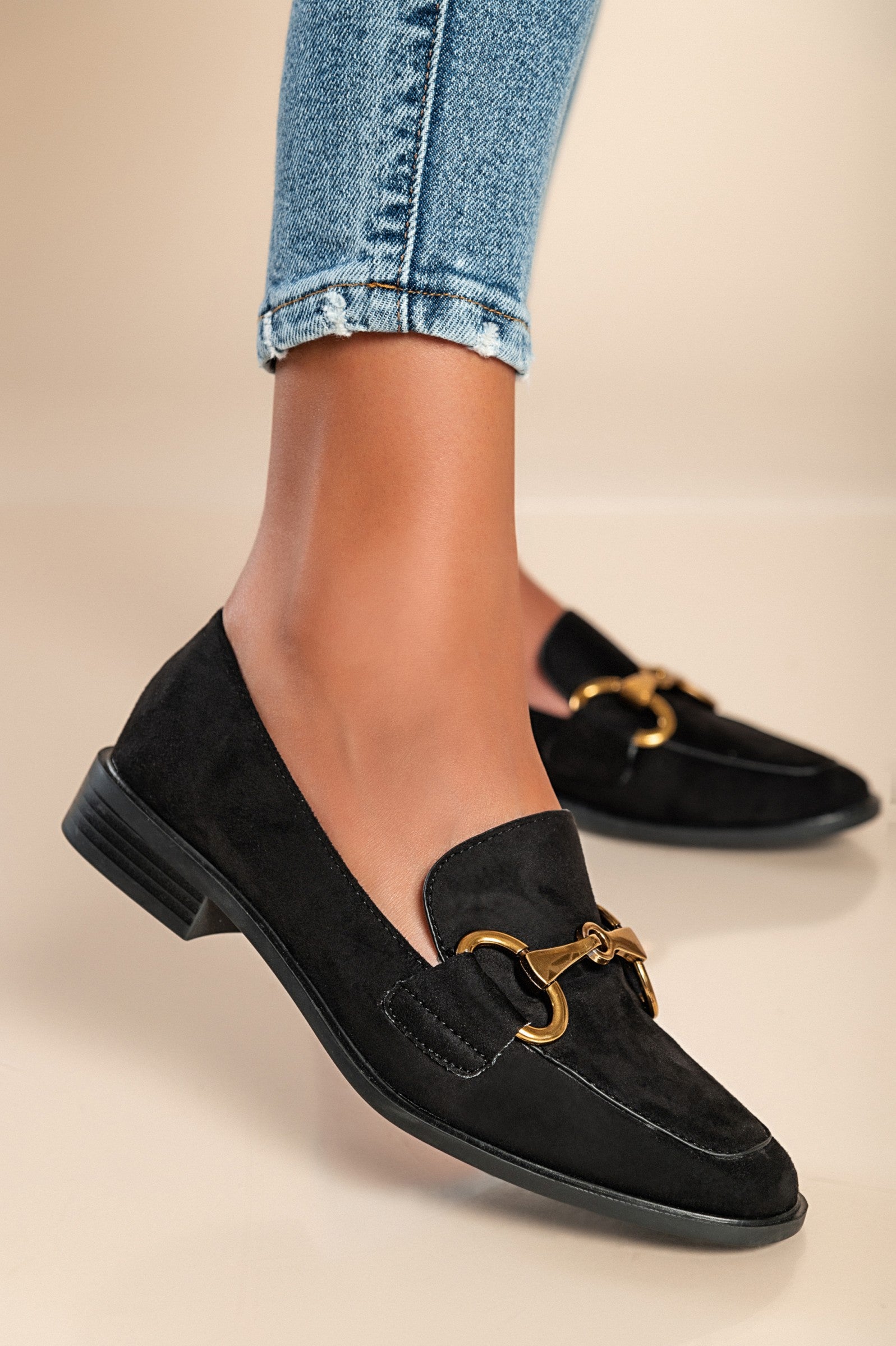 Elegant black moccasins K216 with decorative detail and flat sole, showcasing quality craftsmanship and stylish design.