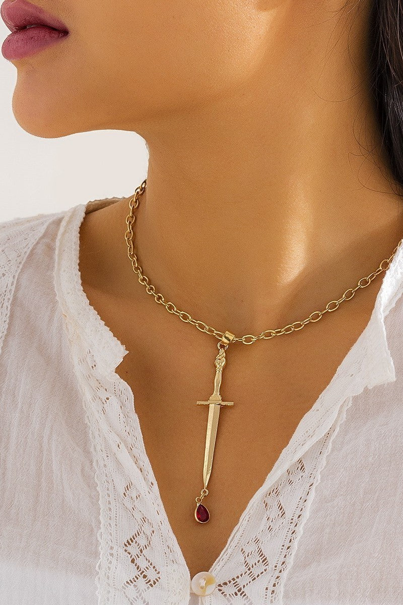Elegant gold necklace with a pendant, featuring smaller chain links and a metal carabiner fastening.