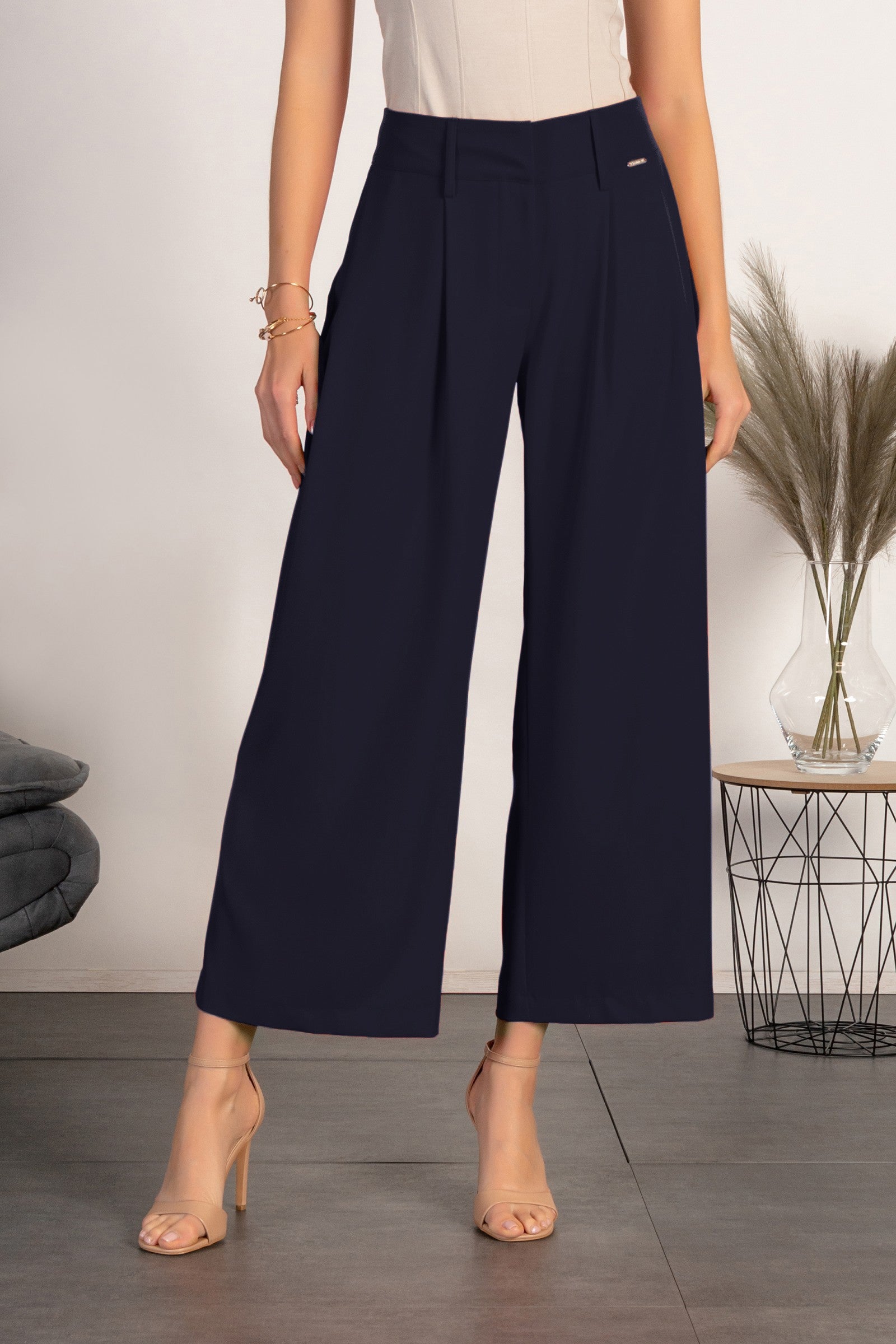 Elegant dark blue pants with loose legs, featuring zip closure and metal hooks, made in Italy.
