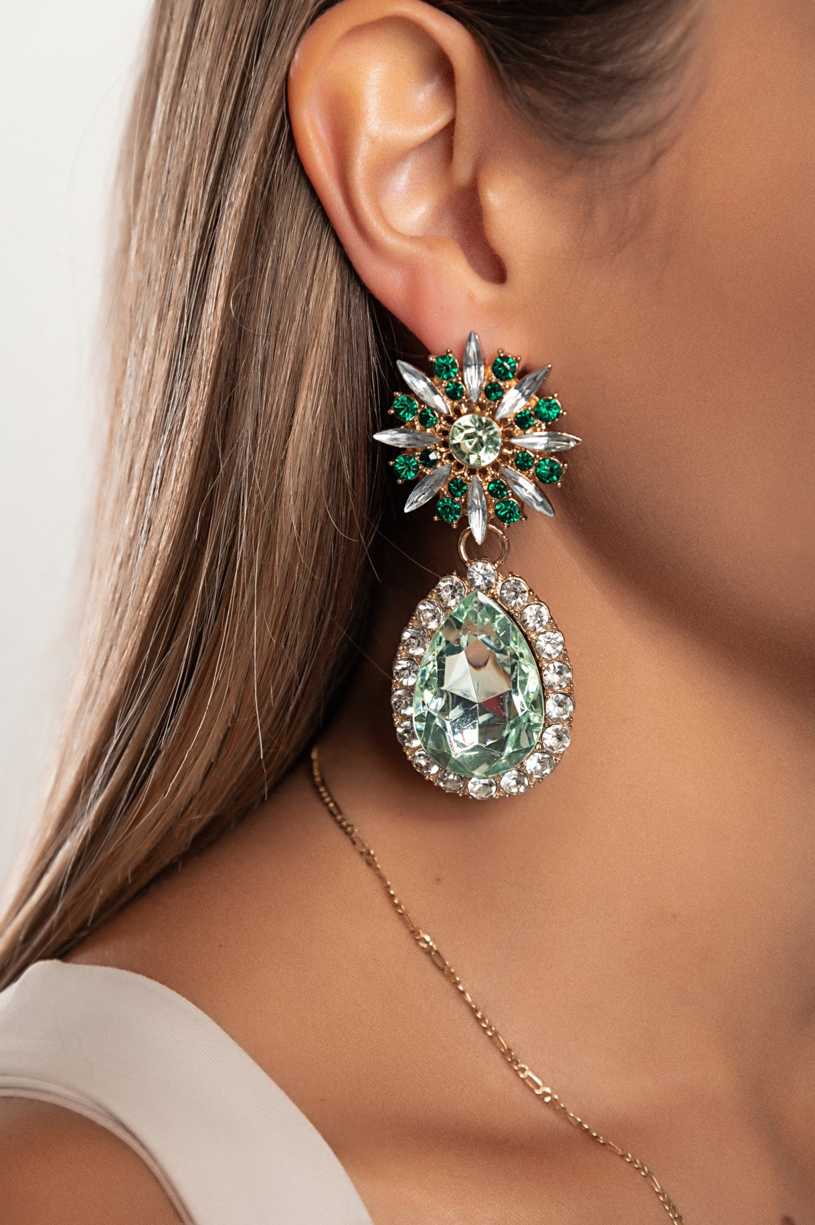Elegant green rhinestone chandelier earrings with intricate design, perfect for enhancing any outfit.