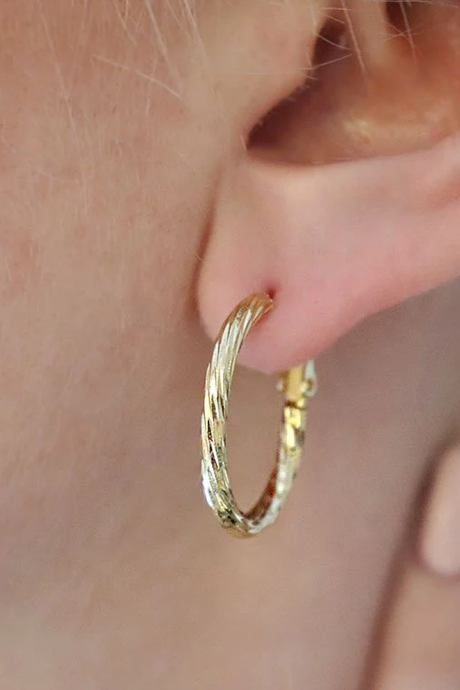 Elegant round earrings in gold color, designed for stylish fashion enhancement.