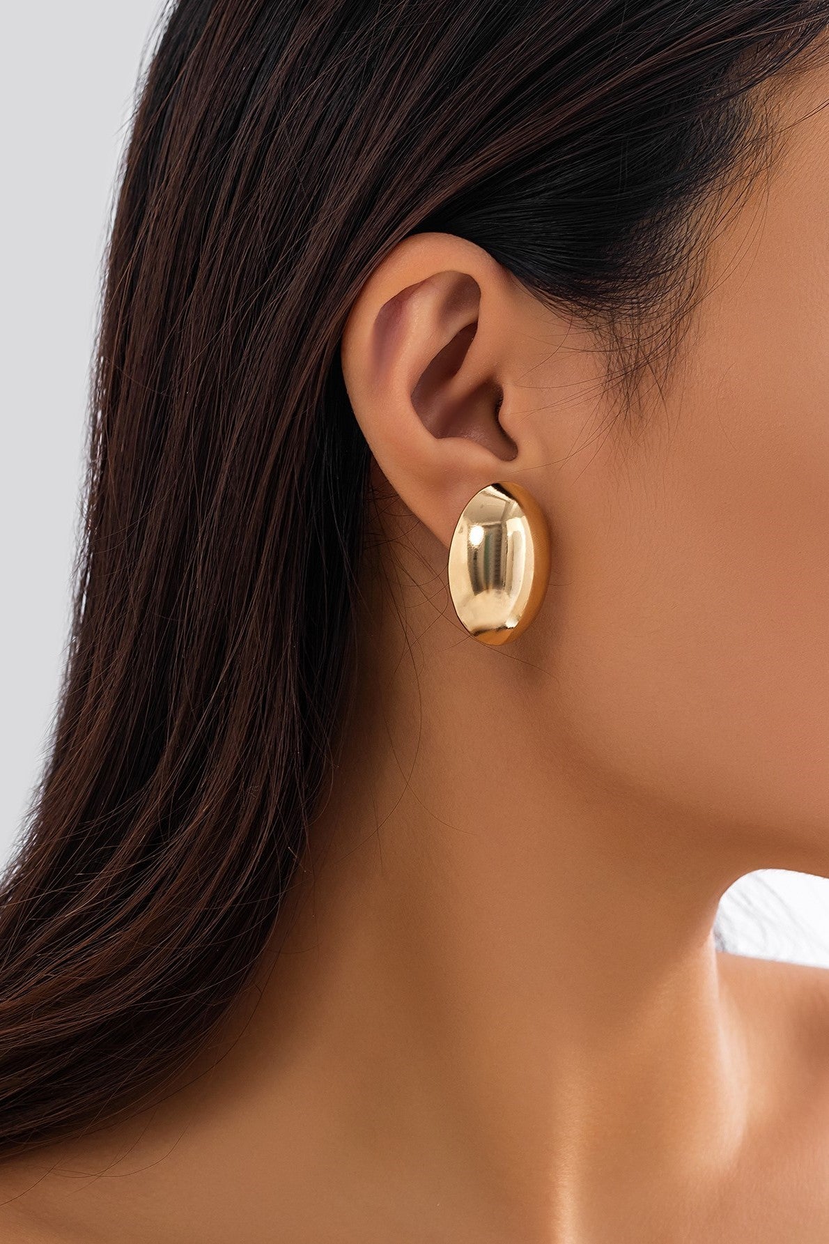 Elegant round gold earrings made from metal alloy, showcasing a classic design.