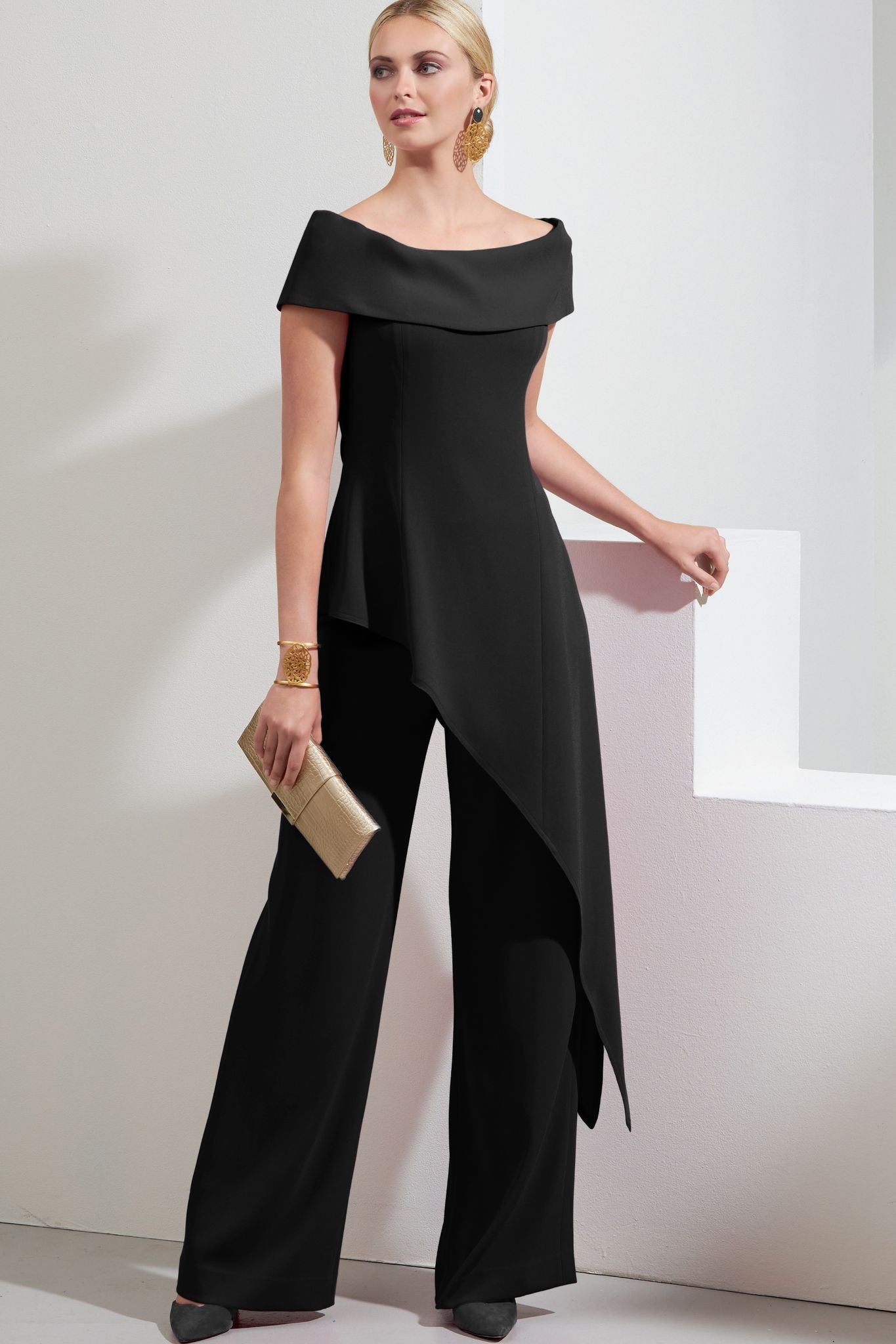Elegant black asymmetrical top with short sleeves and loose trousers, showcasing a modern and stylish outfit.