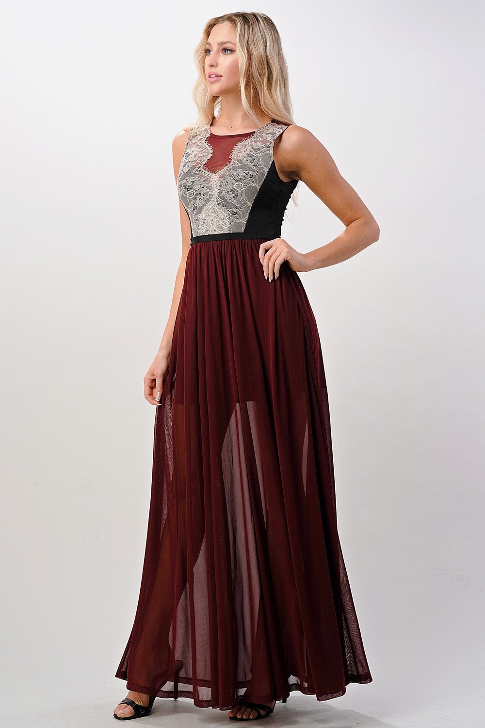 Elegant sheer maxi dress featuring a lace bodice and flowing skirt, perfect for special occasions.