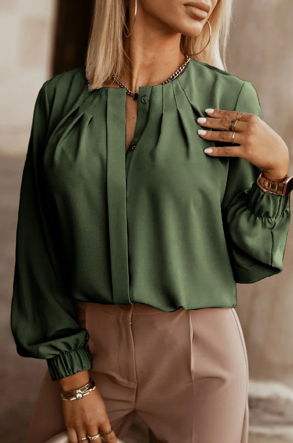 Elegant olive shirt with round neck and long sleeves, featuring button closure and elastic cuffs.