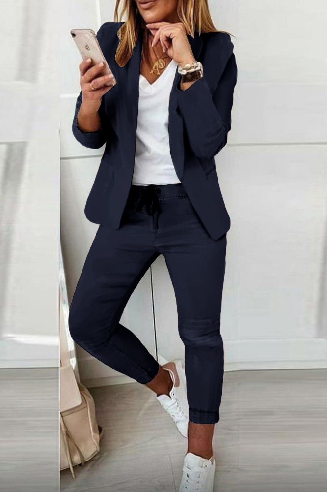 Elegant dark blue trousers and blazer set Estrena, featuring a classic collar, long sleeves, and slim fit trousers with an elastic drawstring waist.