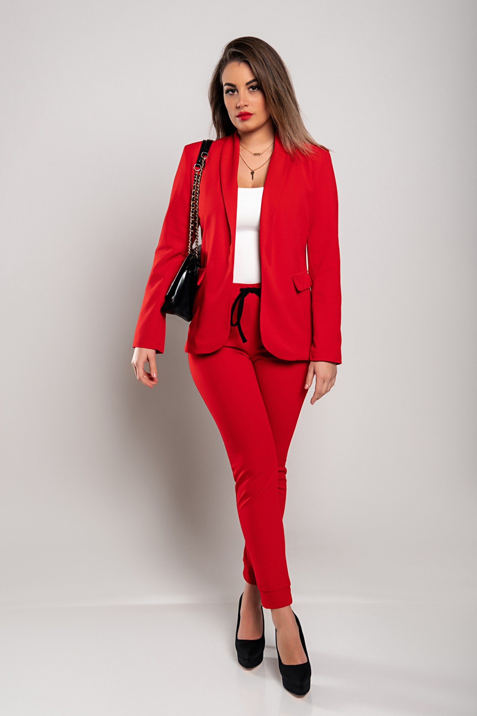 Elegant red trousers and blazer set Estrena, featuring a classic collar, long sleeves, and slim-fit trousers with an elastic drawstring waist.