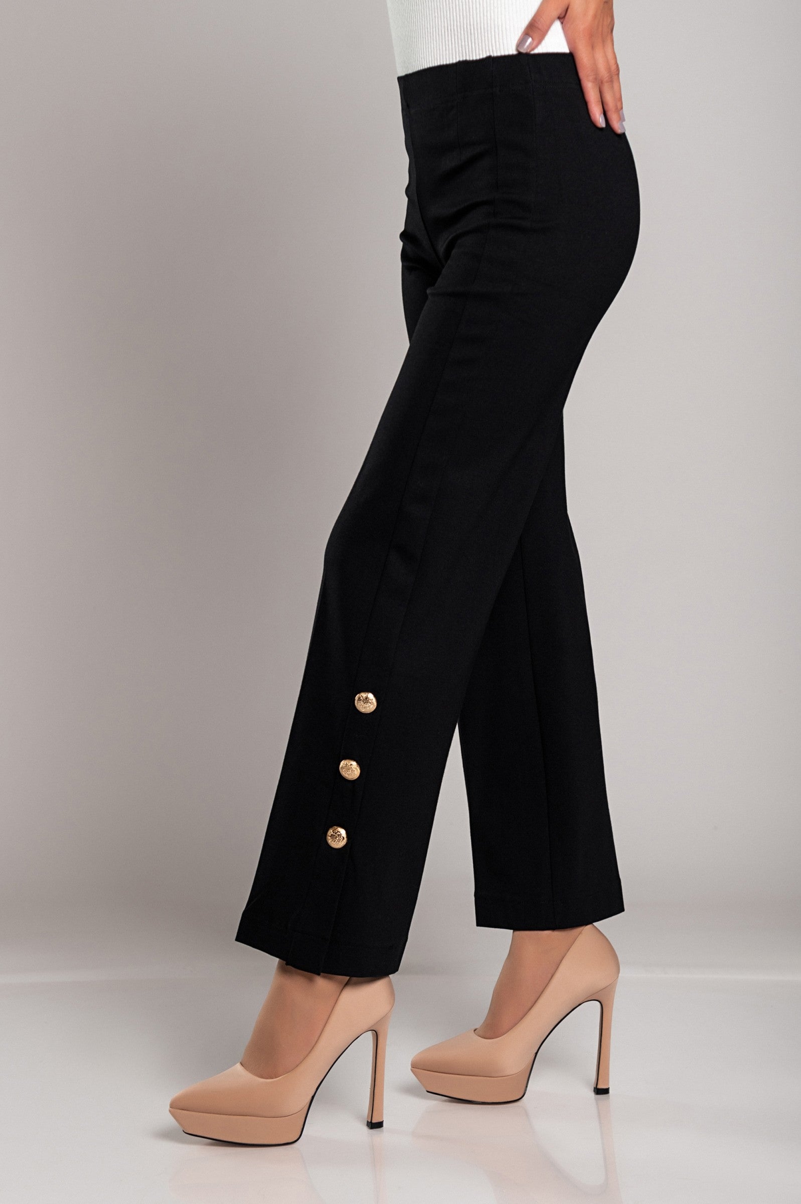 Elegant black trousers with decorative buttons and elasticated waist, showcasing a stylish and comfortable design.