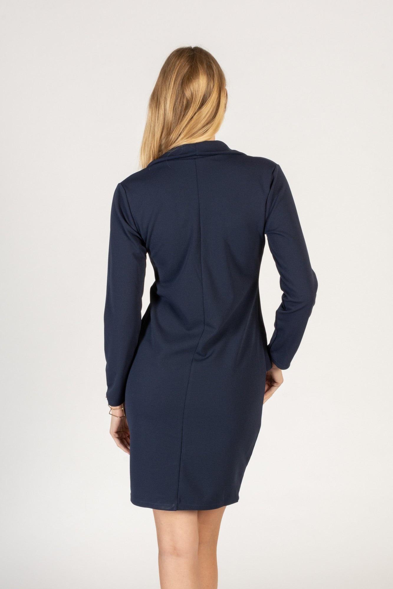 Elegant dark mini dress featuring a 'V' neckline, long sleeves, and decorative buttons, designed for comfort and style.