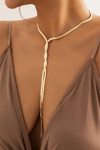 Elegantna prepletena verižica v zlate barve, zapirana s kovinskim karabinom, iz kovinske zlitine.