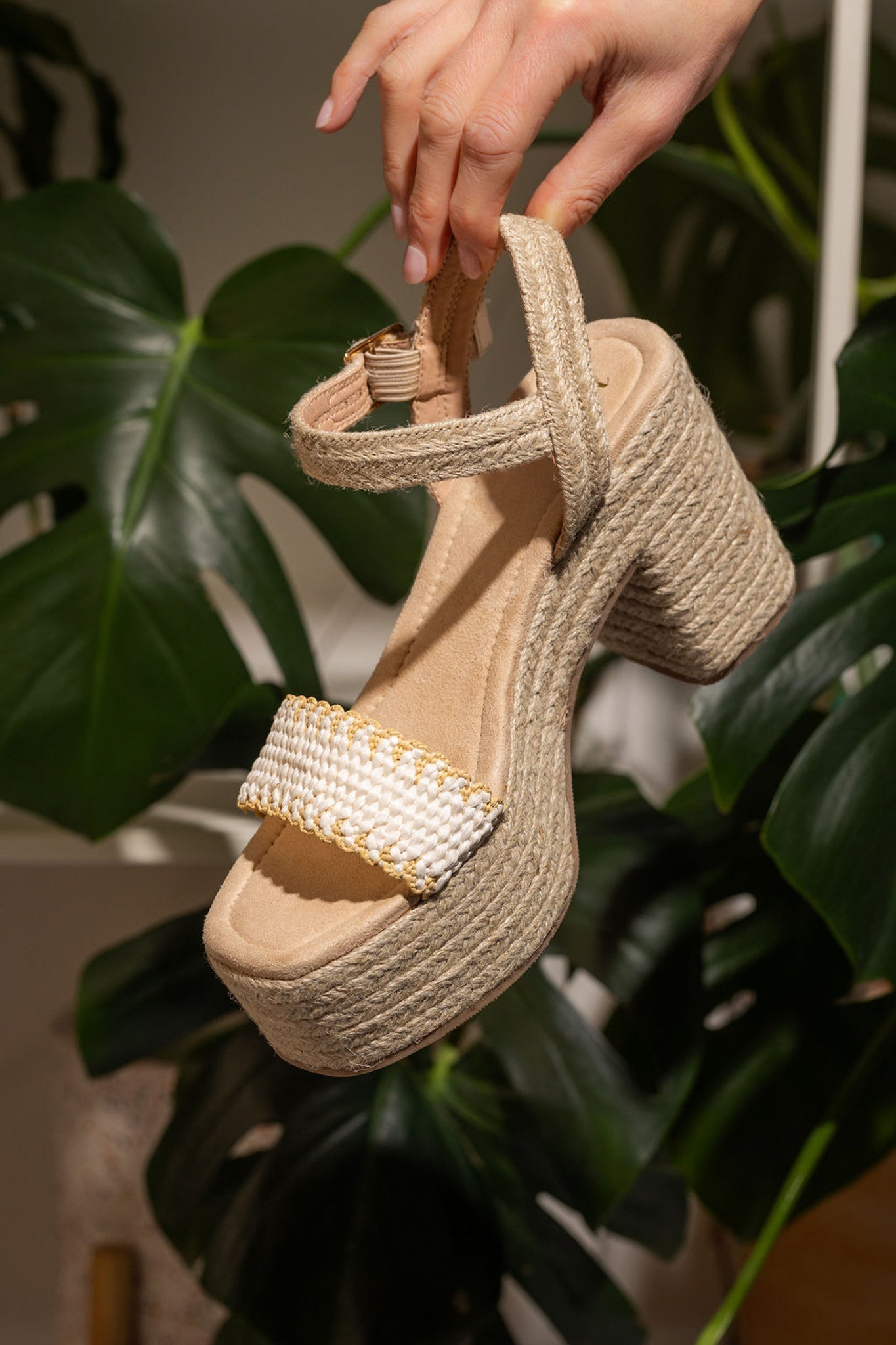 Elise Wedge in Off White featuring a single toe strap and adjustable ankle strap, showcasing a stylish design with a padded footbed.