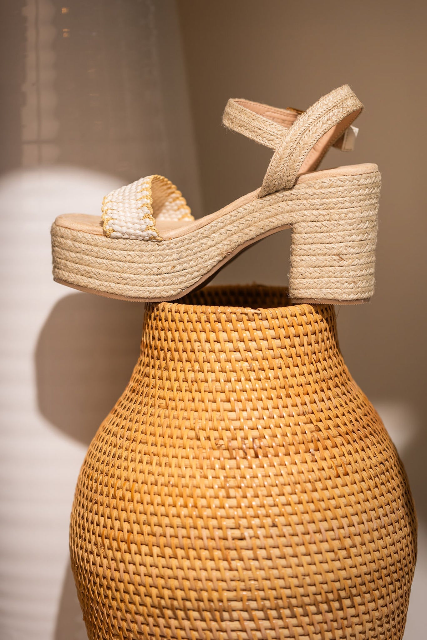 Elise Wedge in Off White featuring a single toe strap and adjustable ankle strap, showcasing a stylish design with a padded footbed.