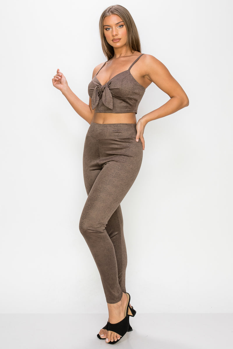A stylish embossed snake print crop top and leggings set in mocha color, featuring a front tie and adjustable straps.