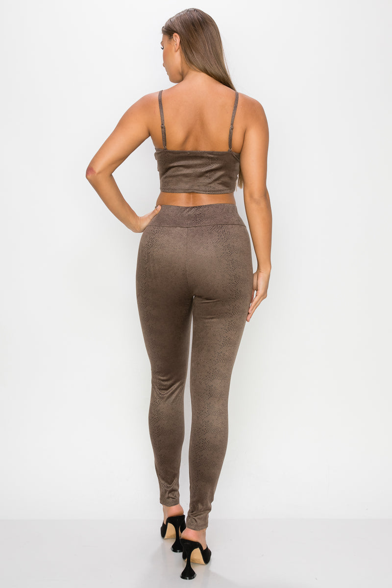A stylish embossed snake print crop top and leggings set in mocha color, featuring a front tie and adjustable straps.