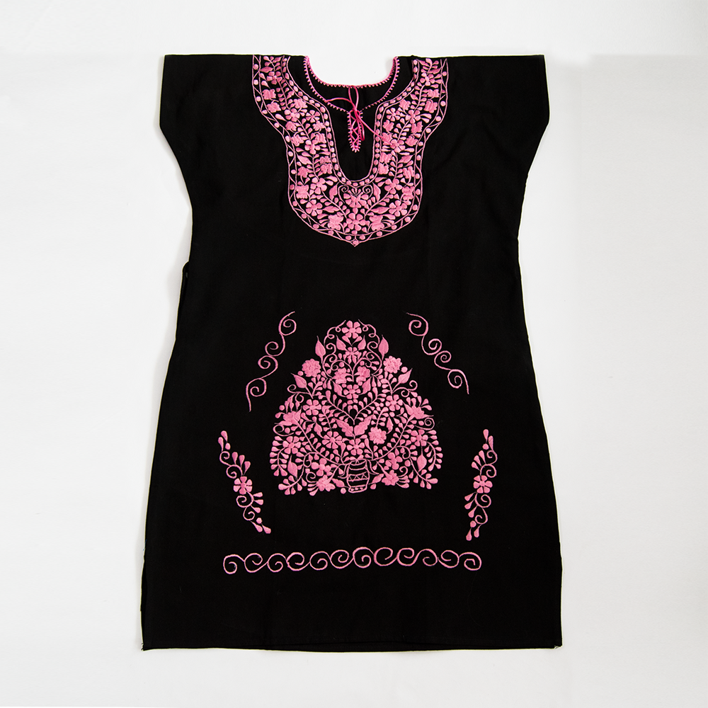 A beautiful embroidered ethnic folk dress featuring vibrant pink floral designs on a black background, showcasing intricate craftsmanship from Puebla, Mexico.