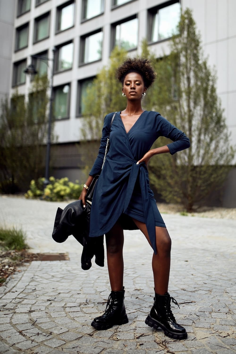 Navy blue envelope dress featuring an asymmetrical bottom, V-neckline, and long tapered sleeves, perfect for various occasions.