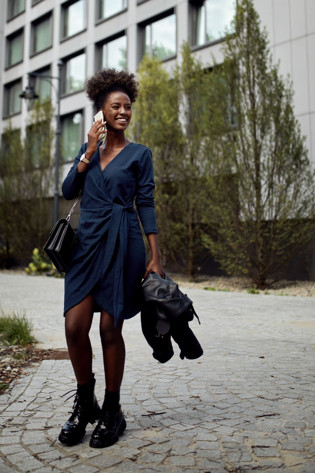 Navy blue envelope dress featuring an asymmetrical bottom, V-neckline, and long tapered sleeves, perfect for various occasions.