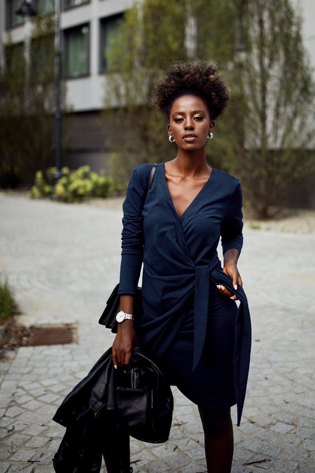 Navy blue envelope dress featuring an asymmetrical bottom, V-neckline, and long tapered sleeves, perfect for various occasions.