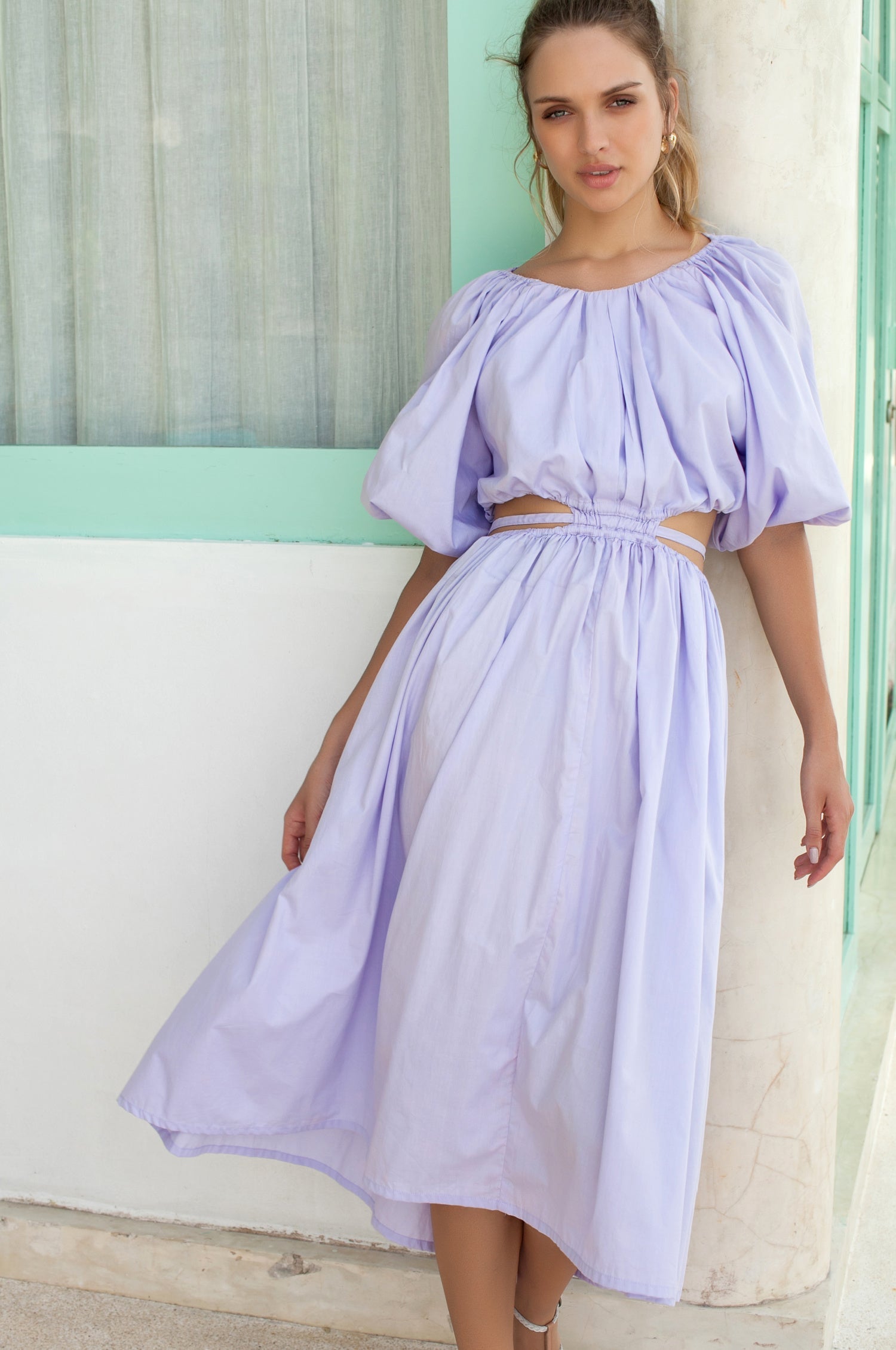 A beautiful Eva Poplin Cotton Cutout Midi Dress featuring puff sleeves, a voluminous skirt, and elegant cutouts at the waist, available in multiple colors.