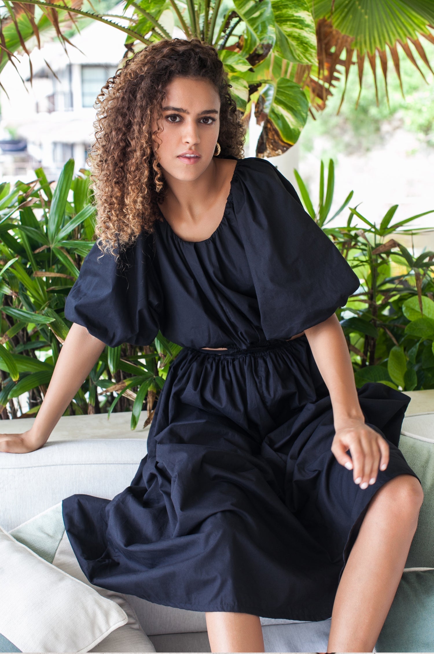 A beautiful Eva Poplin Cotton Cutout Midi Dress featuring puff sleeves, a voluminous skirt, and elegant cutouts at the waist, available in multiple colors.