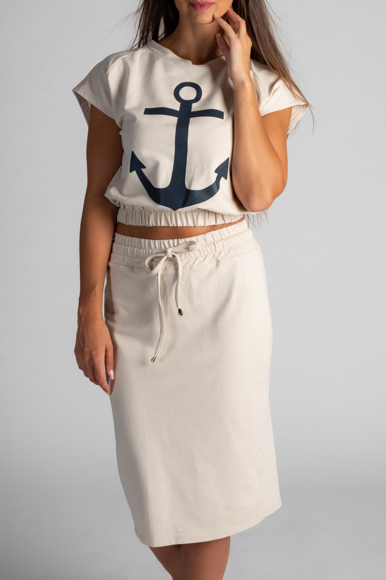Fashion set featuring a cropped beige T-shirt with anchor print and a matching midi skirt, showcasing stylish design and comfort.