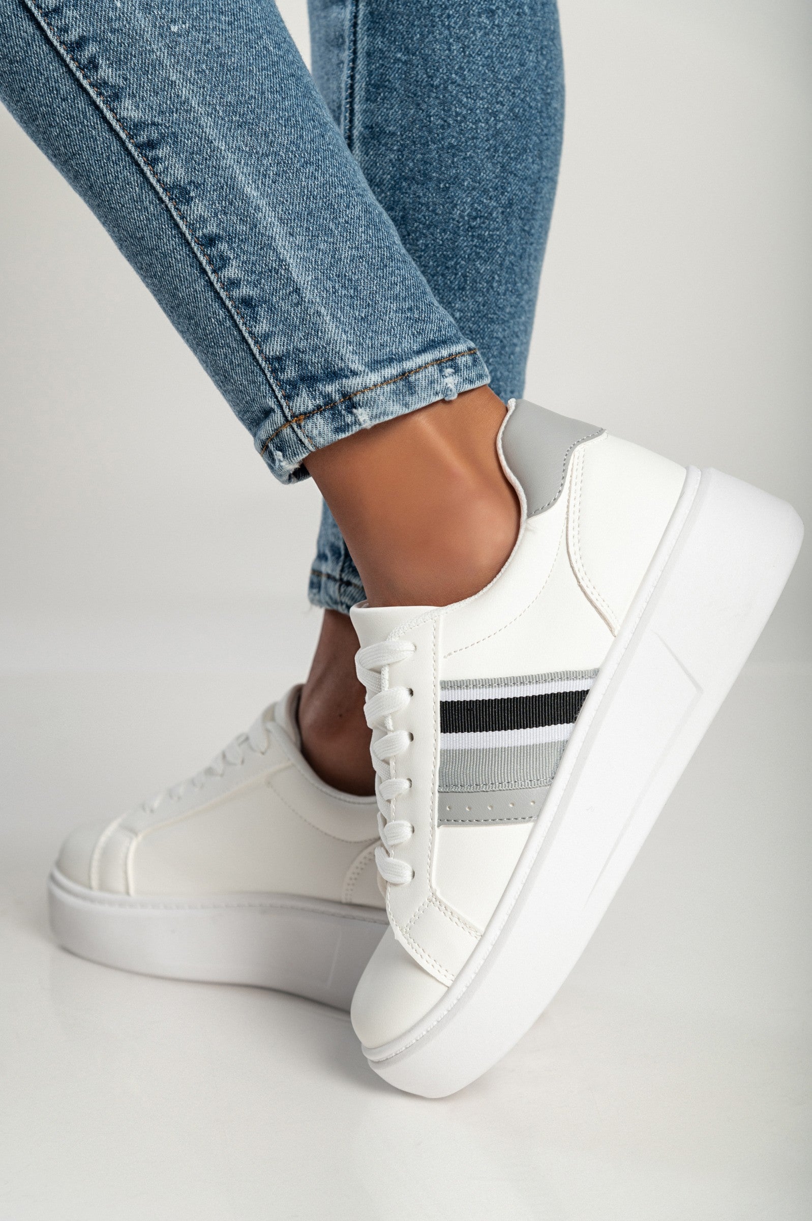 White-silver fashion sneakers with flat sole and round toe, featuring a tie closure, perfect for stylish comfort.