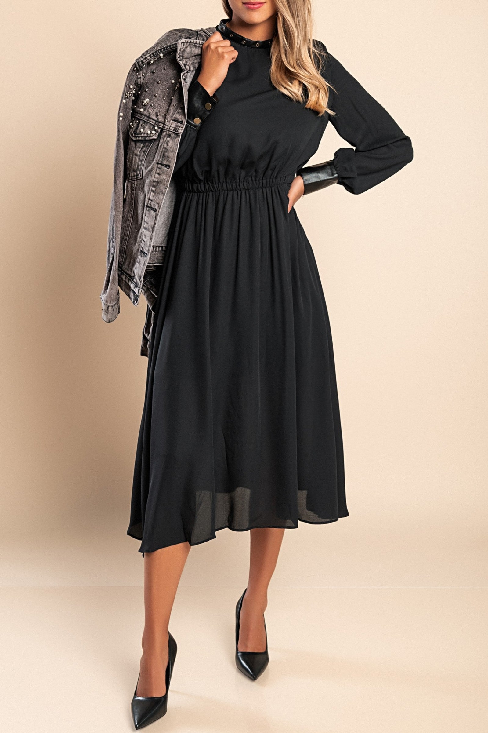 Elegant black midi dress with faux leather details, featuring a round neckline, long sleeves, and an elastic waist.