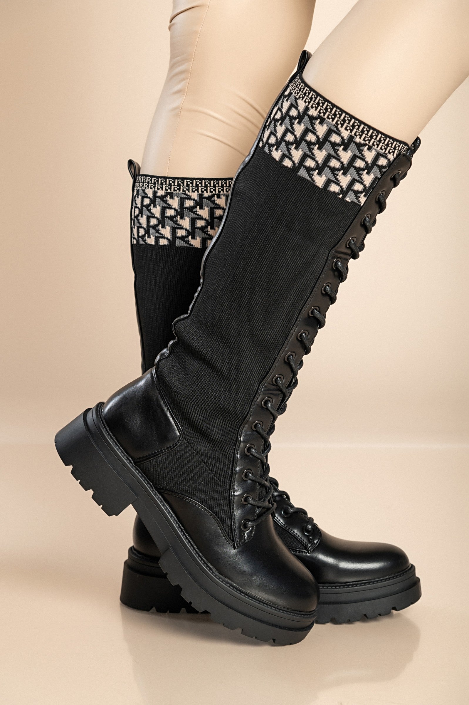 Stylish black faux leather lace-up boots with a low heel and round toe, featuring a zip closure and laces.