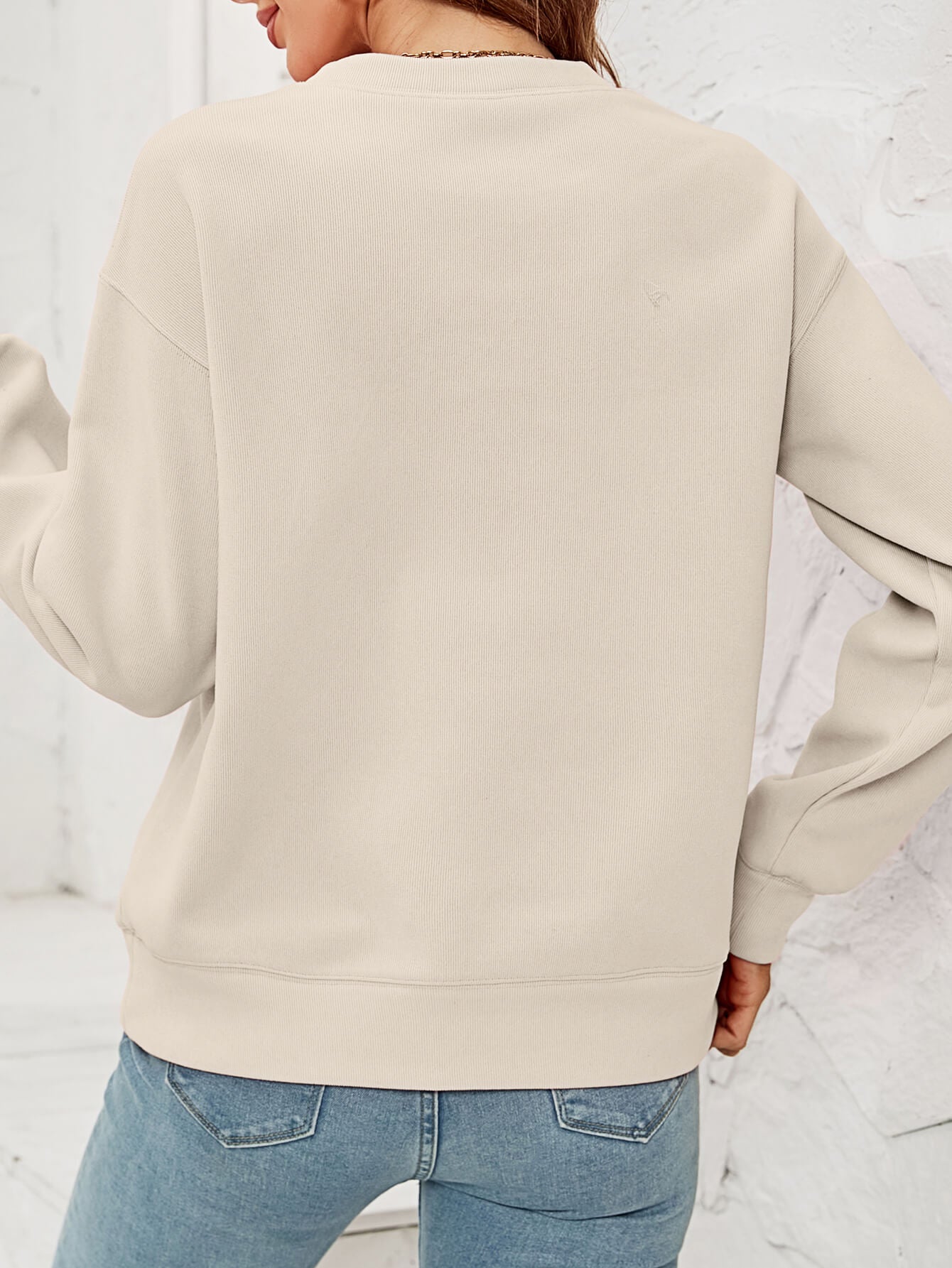 Feliz Navidad Graphic Crewneck Sweatshirt in a studio setting, featuring a festive design and casual style.