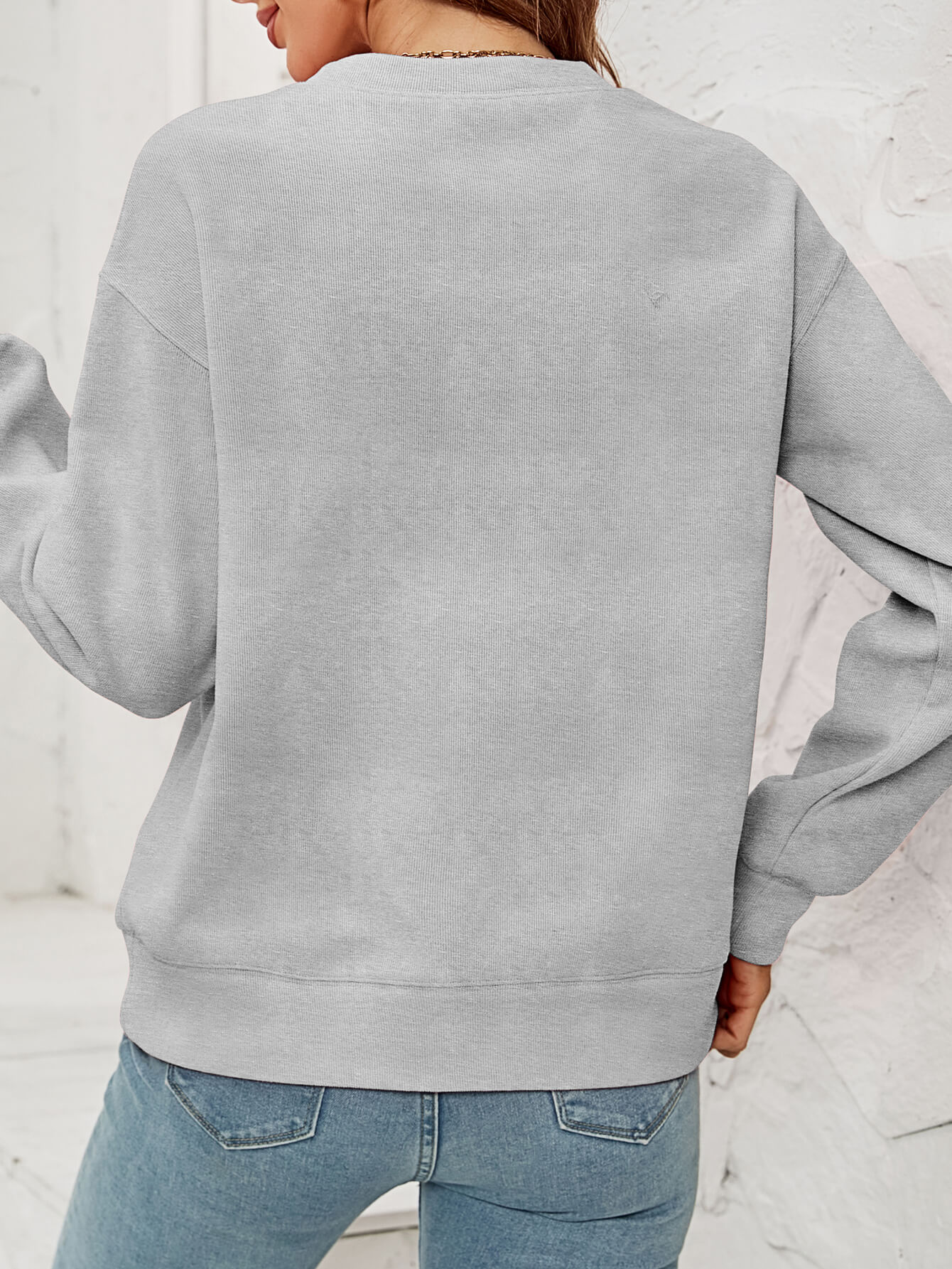 Feliz Navidad Graphic Crewneck Sweatshirt in a studio setting, featuring a festive design and casual style.