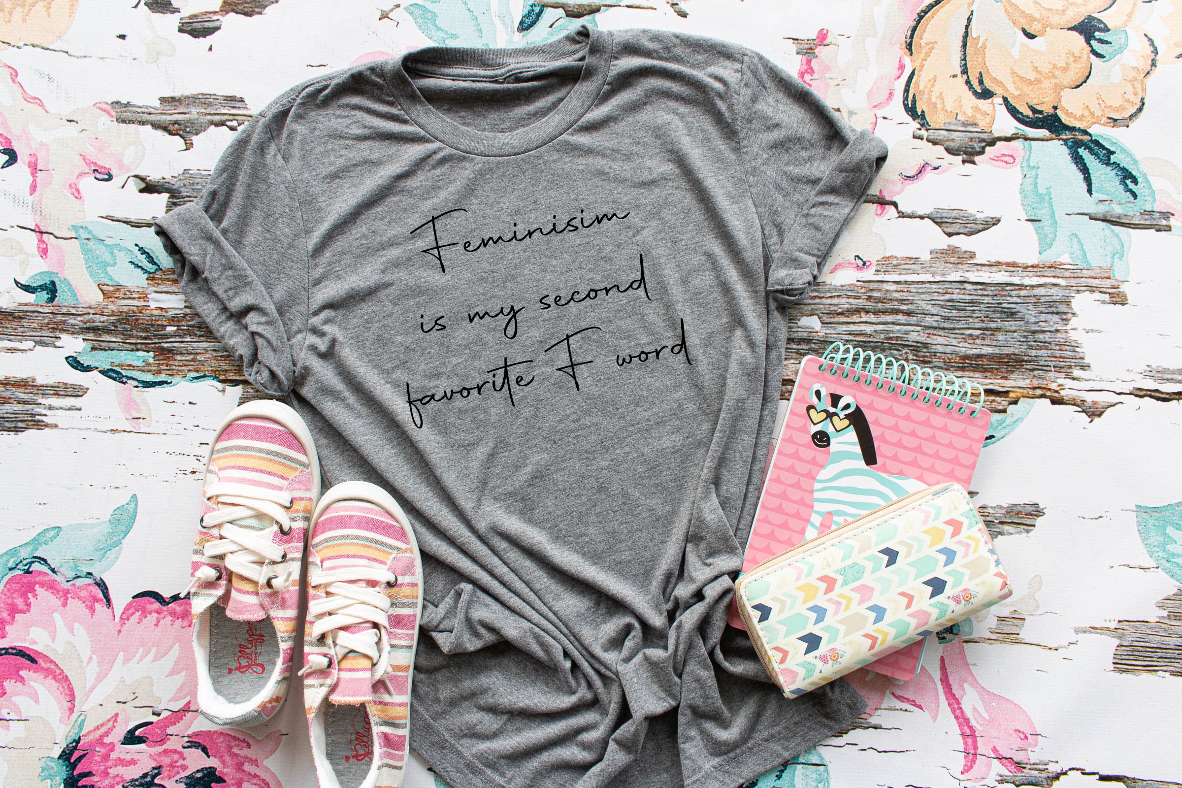 A stylish black tee and tank top featuring the phrase 'Feminism is my second favorite F Word' in bold design.