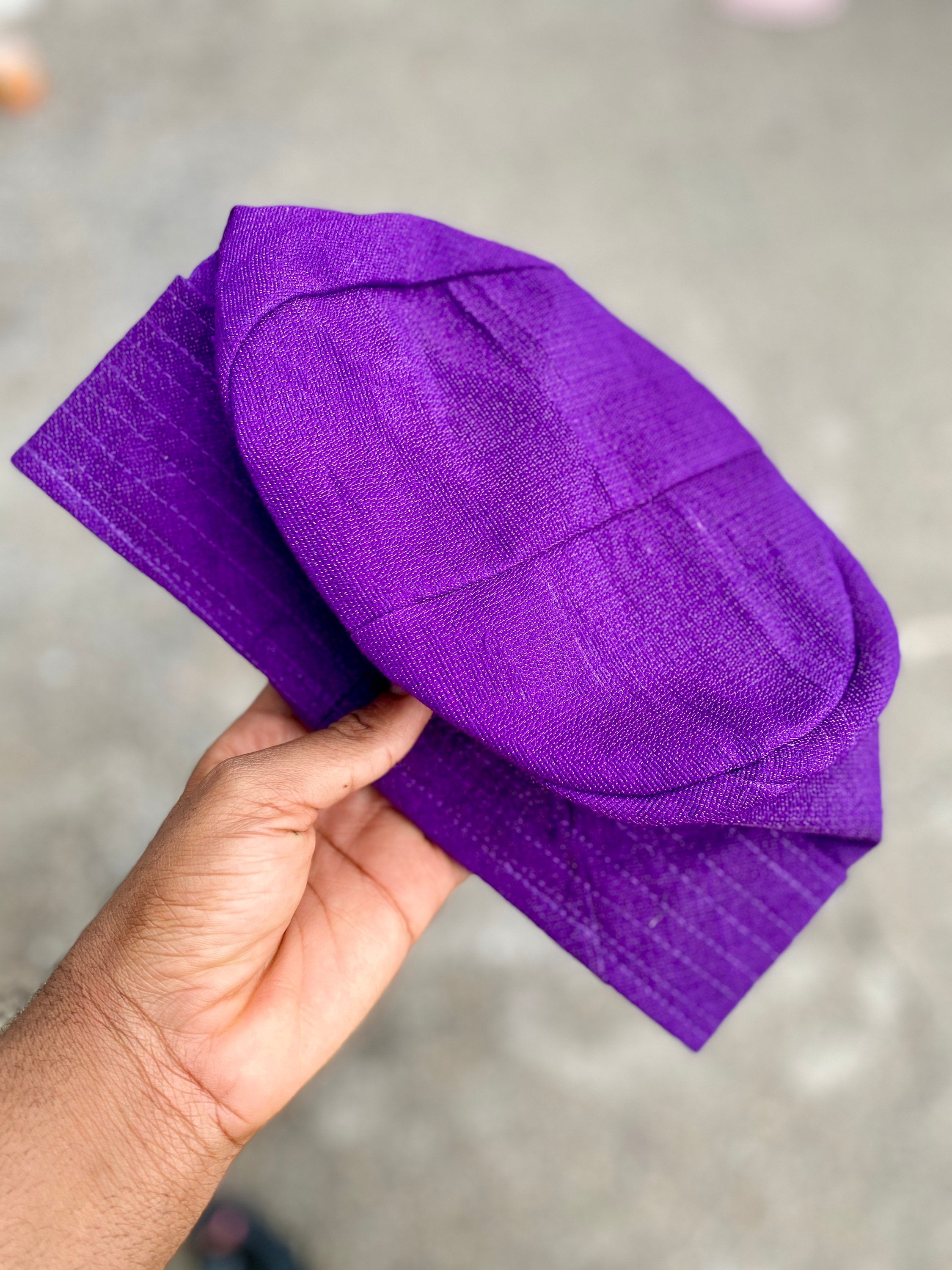 A colorful Fila hat made from handwoven asooke fabric, showcasing intricate patterns and vibrant colors, suitable for all ages.