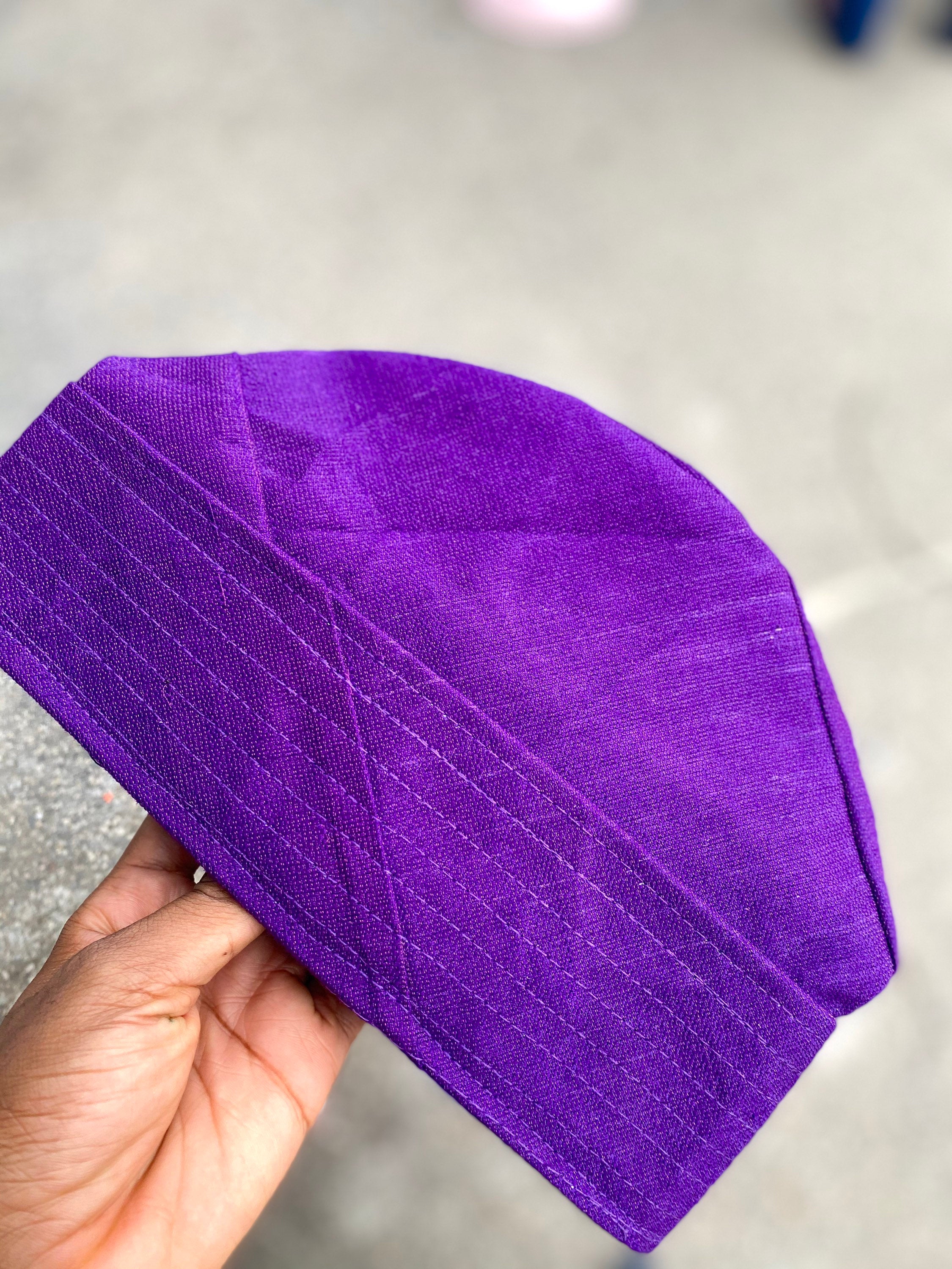 A colorful Fila hat made from handwoven asooke fabric, showcasing intricate patterns and vibrant colors, suitable for all ages.