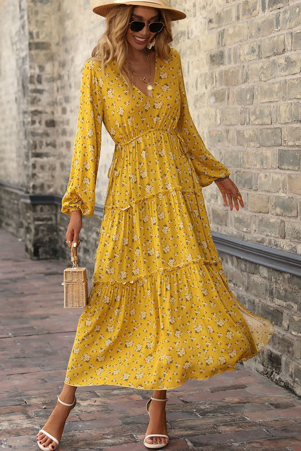 A beautiful floral frill trim tiered dress with balloon sleeves, showcasing a plunge neckline and a flowing maxi length.