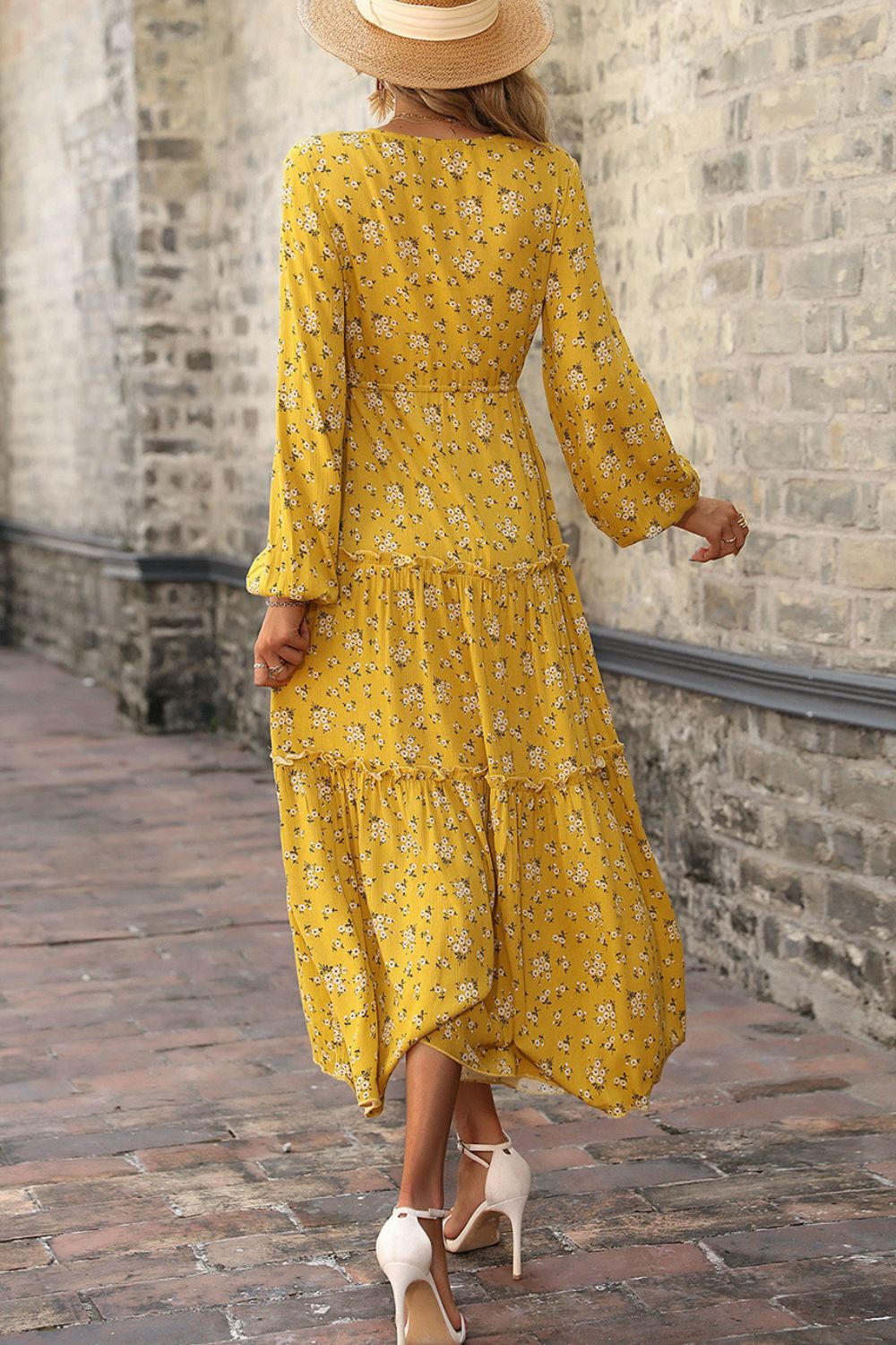 A beautiful floral frill trim tiered dress with balloon sleeves, showcasing a plunge neckline and a flowing maxi length.